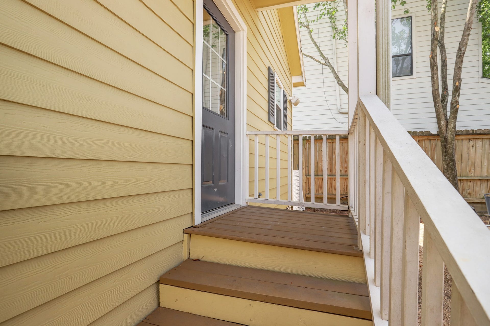 803 Dorothy Street, Houston, TX 77007 Convenient back entrance with a private staircase, offering easy access between the home and fenced backyard.