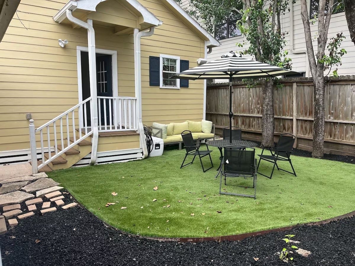 803 Dorothy Street, Houston, TX 77007 Private fenced backyard with mature trees and a patio area for relaxing outdoors.