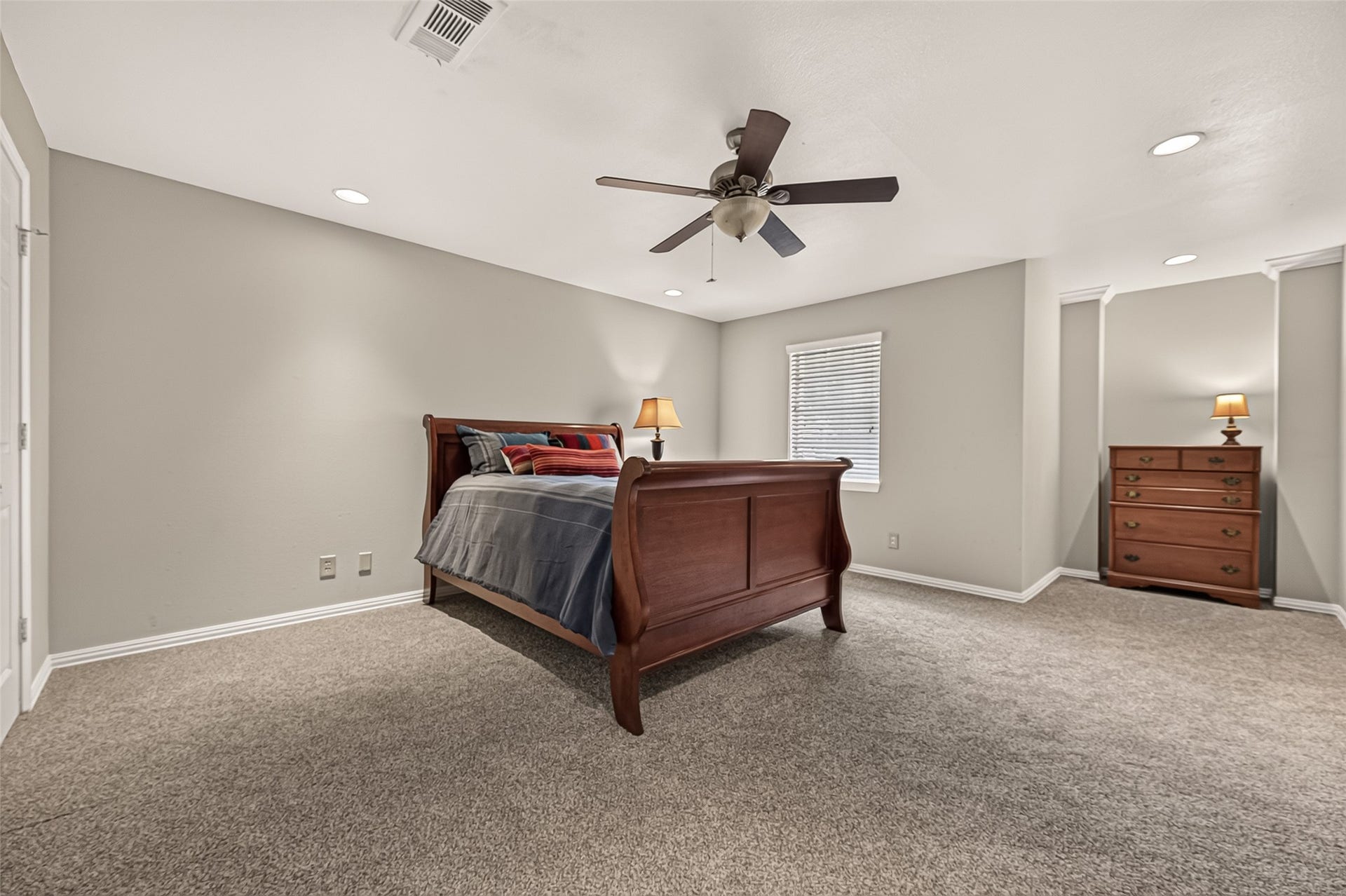 8007 Vickridge Lane, Spring, TX 77379 Spacious primary bedroom with abundant natural light and a dedicated dresser niche