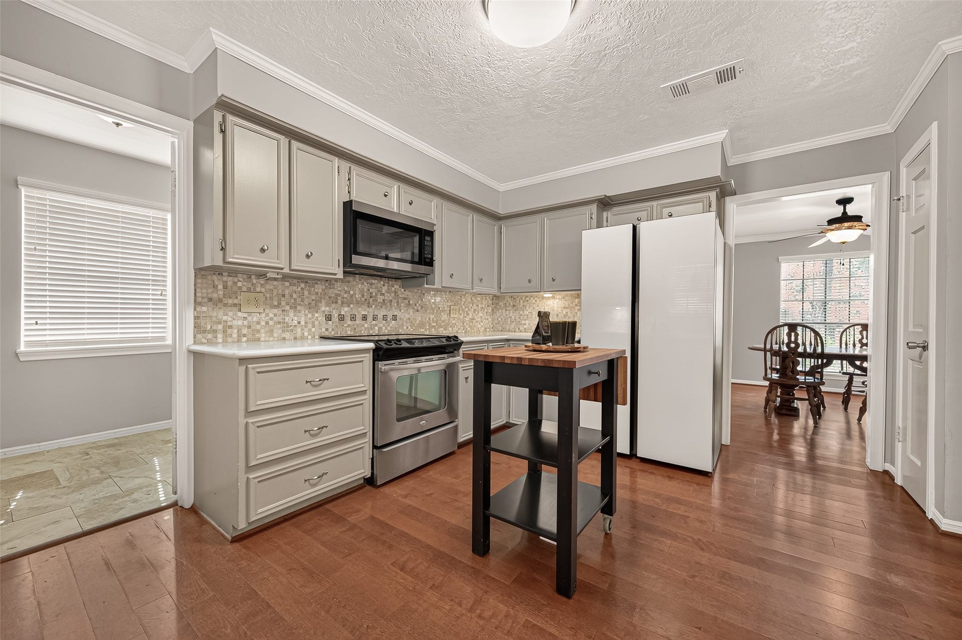 8007 Vickridge Lane, Spring, TX 77379 Plenty of workspace and storage surround the kitchen, with warm wood floors adding character and a comfortable, welcoming feel