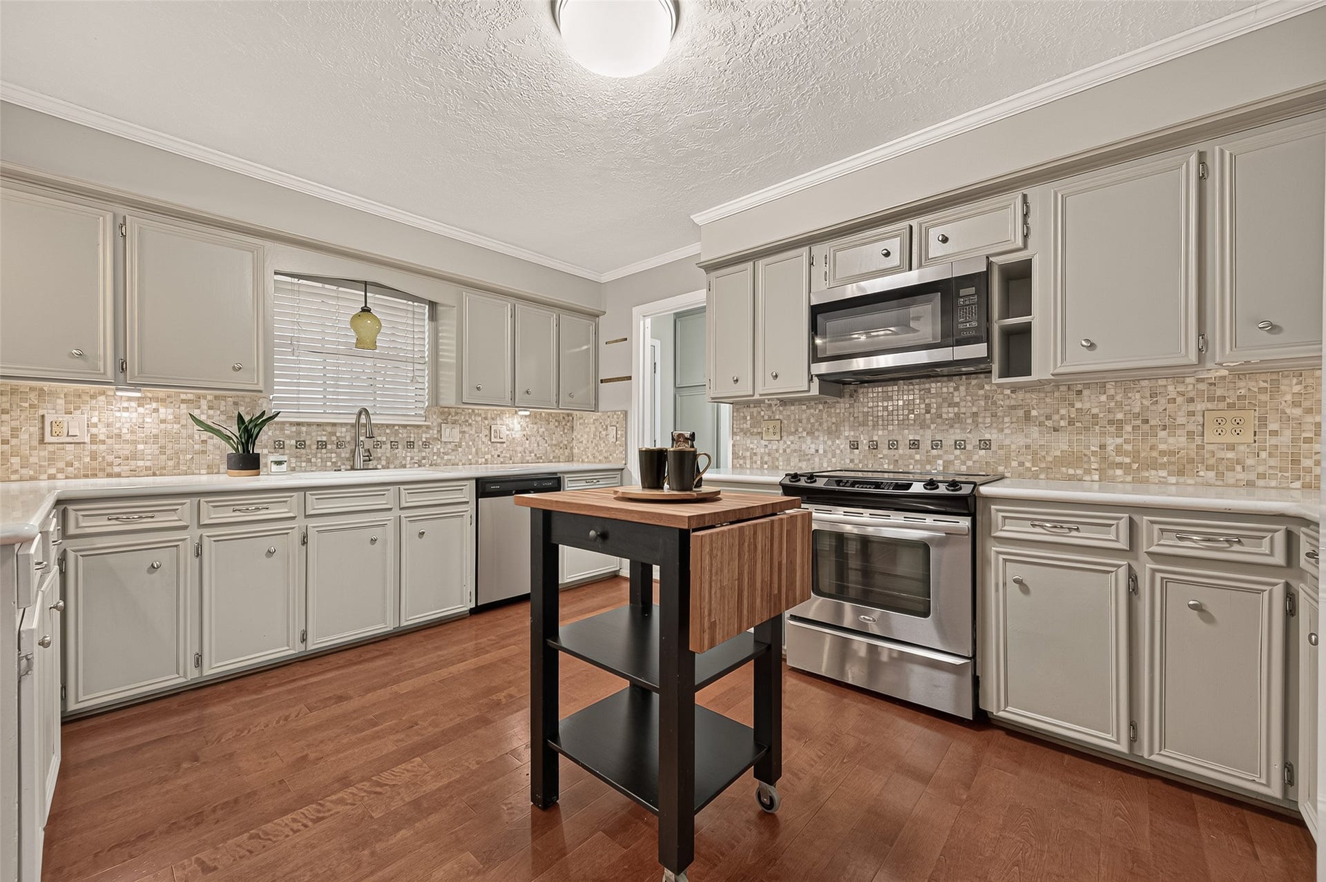 8007 Vickridge Lane, Spring, TX 77379 A well-appointed kitchen with abundant cabinetry, stainless-steel appliances, and a movable island for added prep and serving space