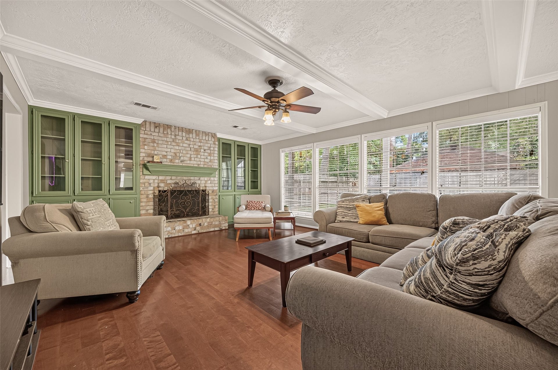8007 Vickridge Lane, Spring, TX 77379 Gather, relax, and enjoy the warmth of this inviting living room, where a beautiful brick fireplace and wall of windows create a comfortable place to call home