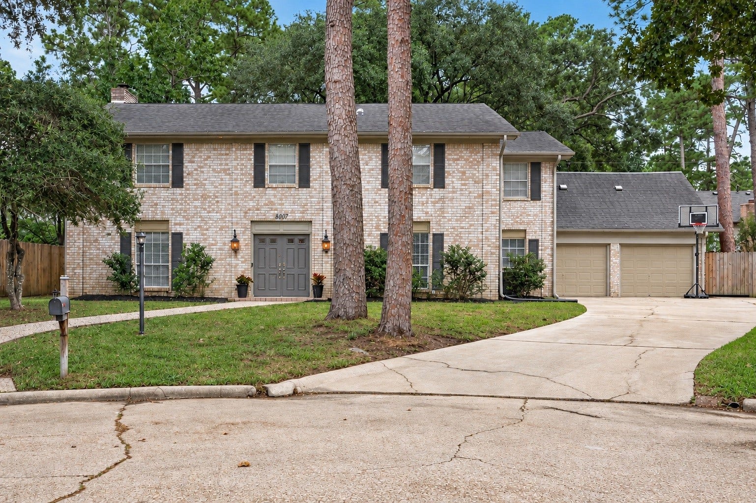 8007 Vickridge Lane, Spring, TX 77379 A welcoming first impression! Classic brick, mature trees, established landscaping, and a spacious driveway create inviting curb appeal from the moment you arrive