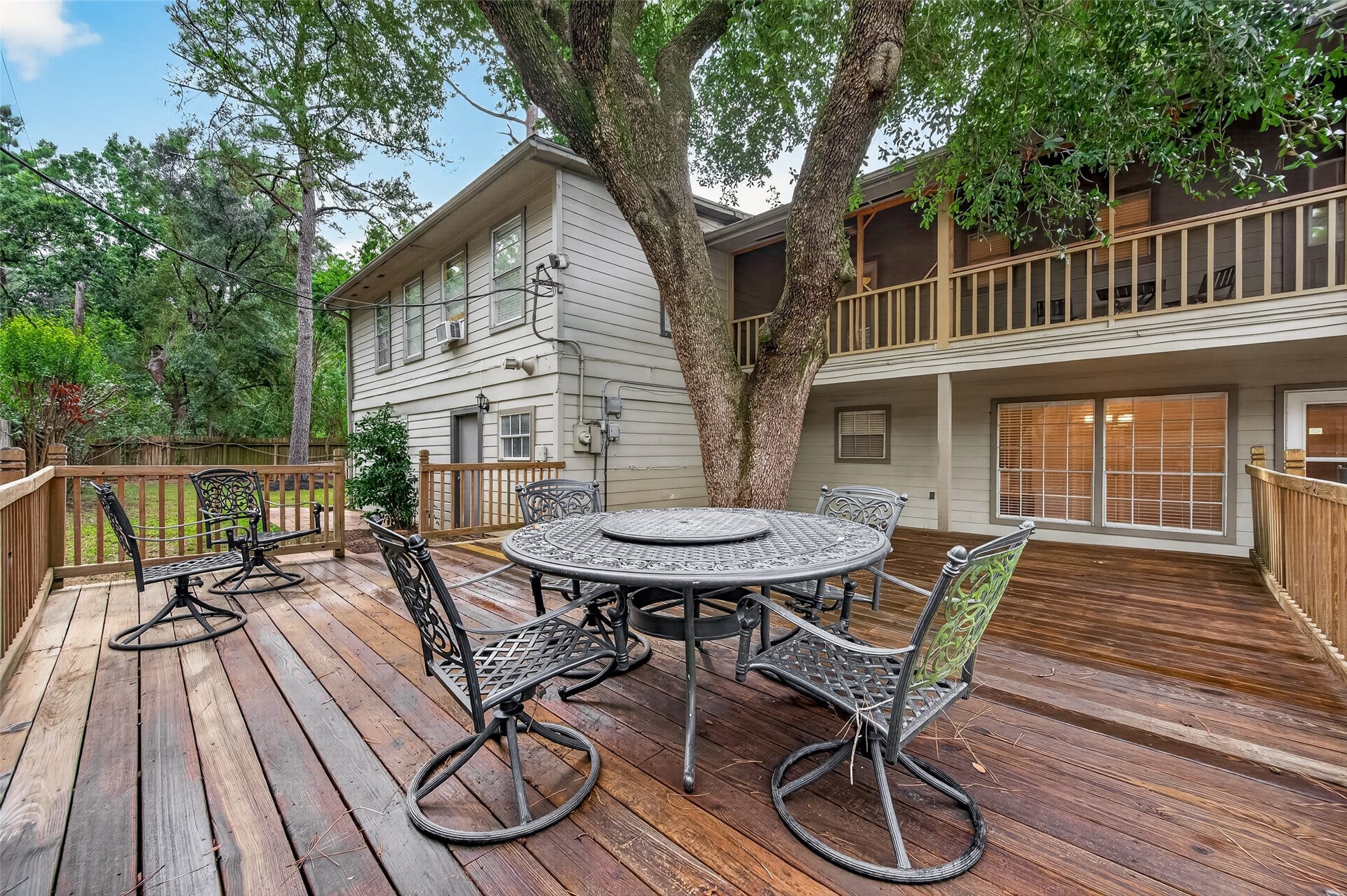 8007 Vickridge Lane, Spring, TX 77379 Inviting shaded deck beneath a mature treeideal for relaxing and entertaining.