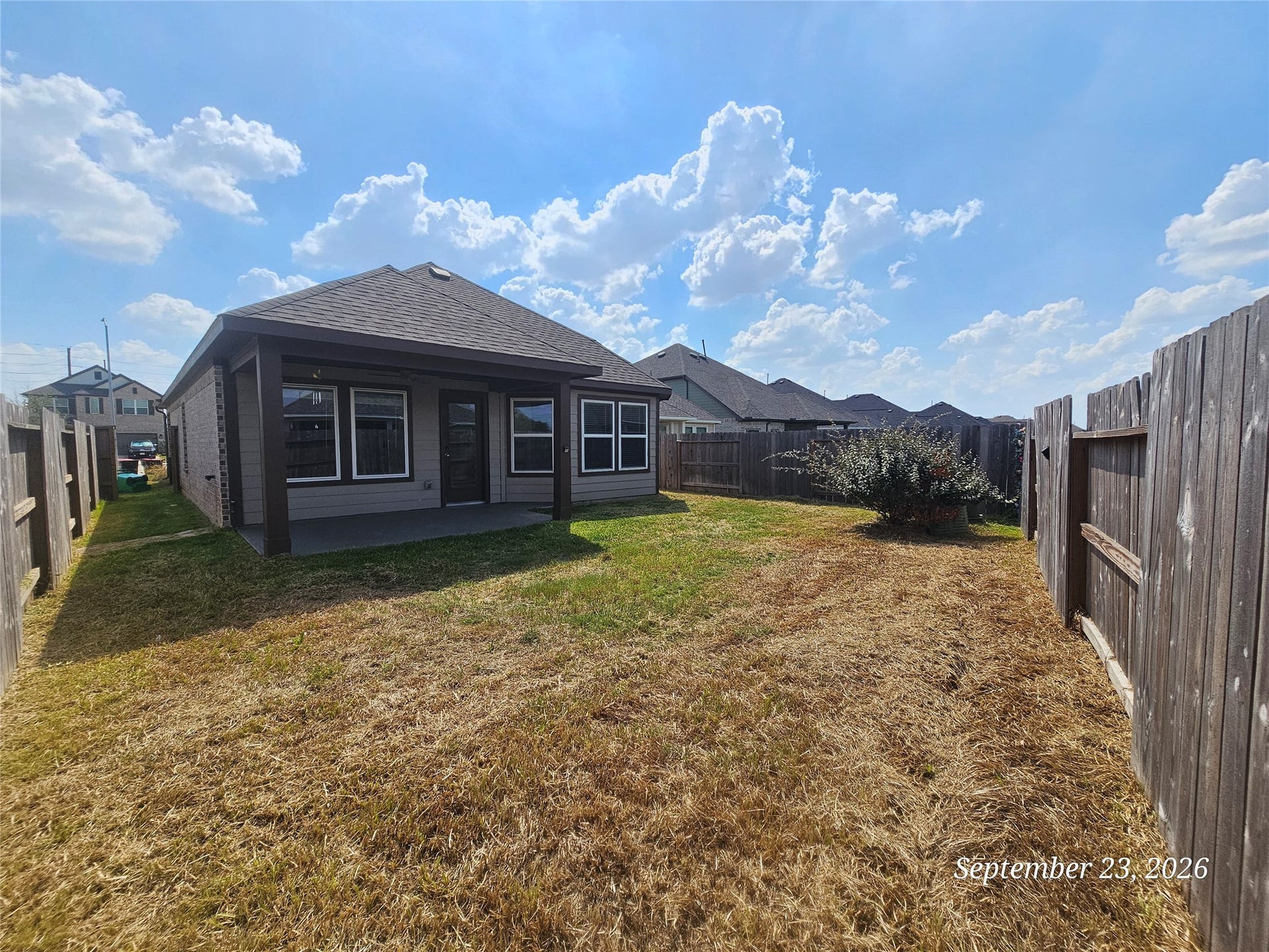 21614 Wave Hollow Drive, Cypress, TX 77433 Large backyard with cover patio and a fan for staying fresh. Also an exterior gas connection for your grill.