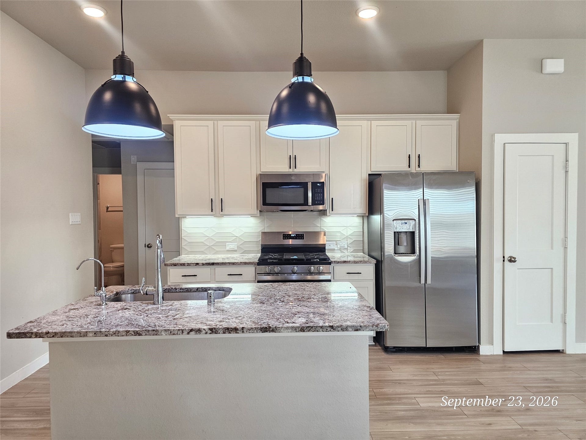 21614 Wave Hollow Drive, Cypress, TX 77433 Beautiful kitchen with island and pendant lights.