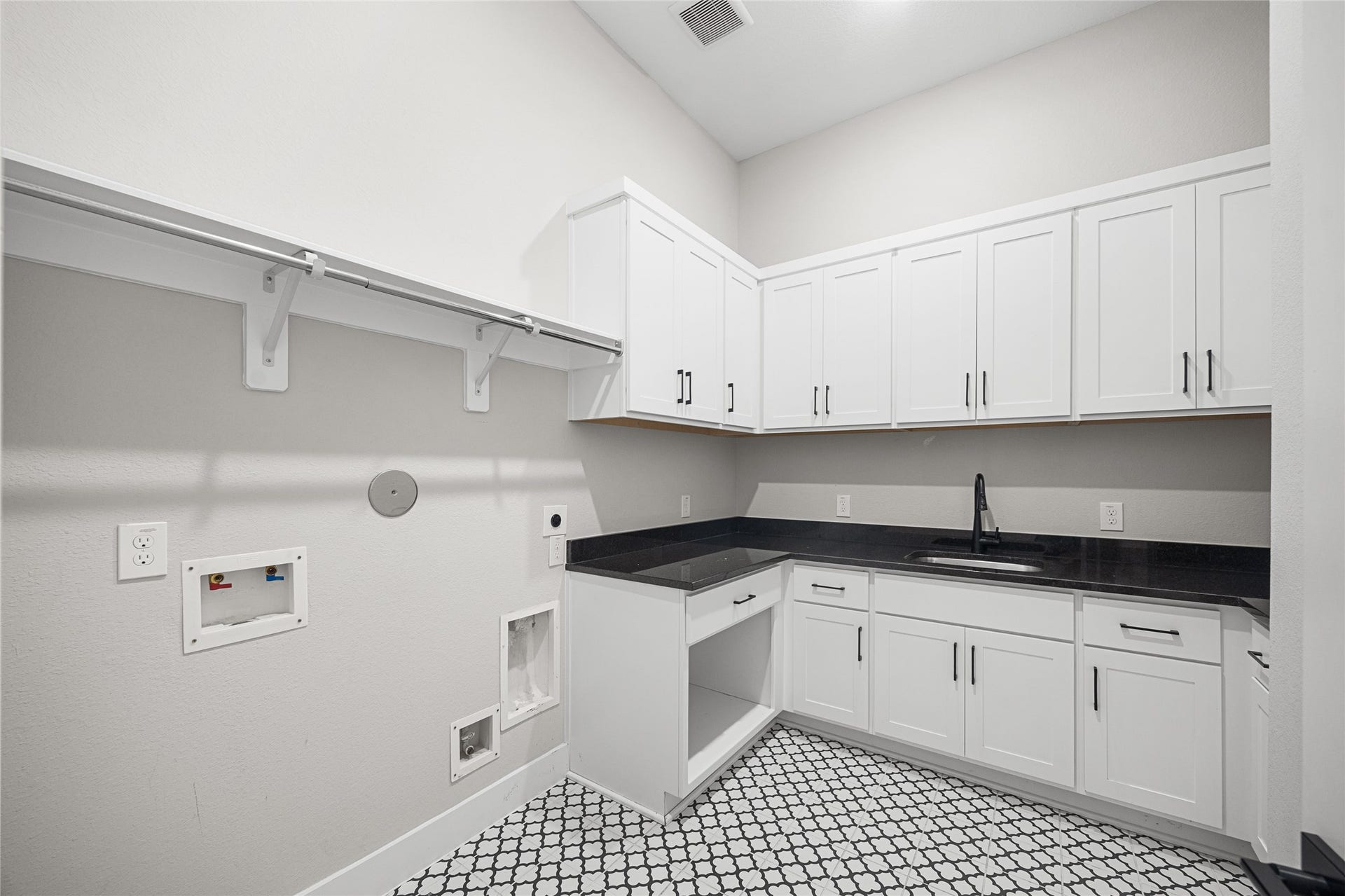 6707 Nimitz Court, Katy, TX 77493 Spacious utility room with extensive cabinetry, a sink, and ample counter space for folding and organization, paired with a dedicated area for washer and dryer.