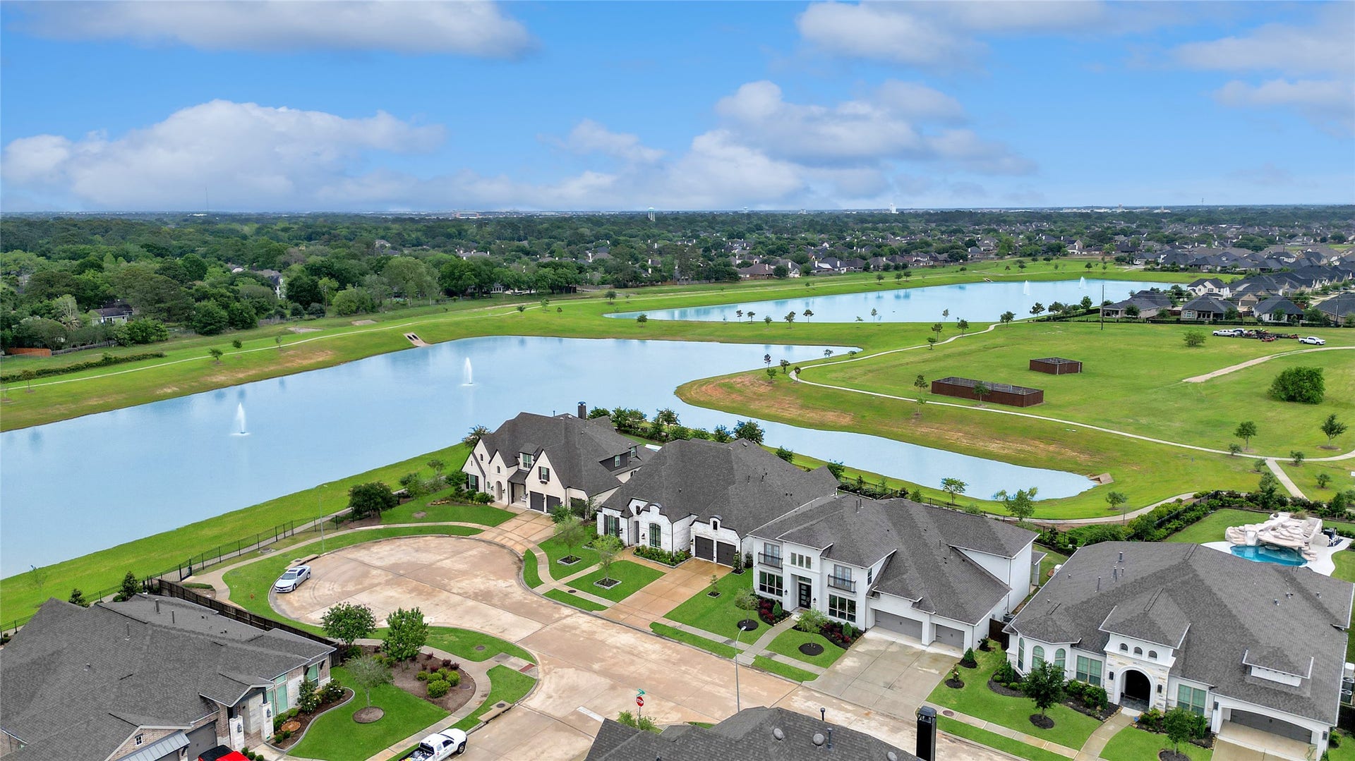 6707 Nimitz Court, Katy, TX 77493 Elevated perspective showcasing the surrounding community with scenic water features, walking paths, and thoughtfully planned green spaces.