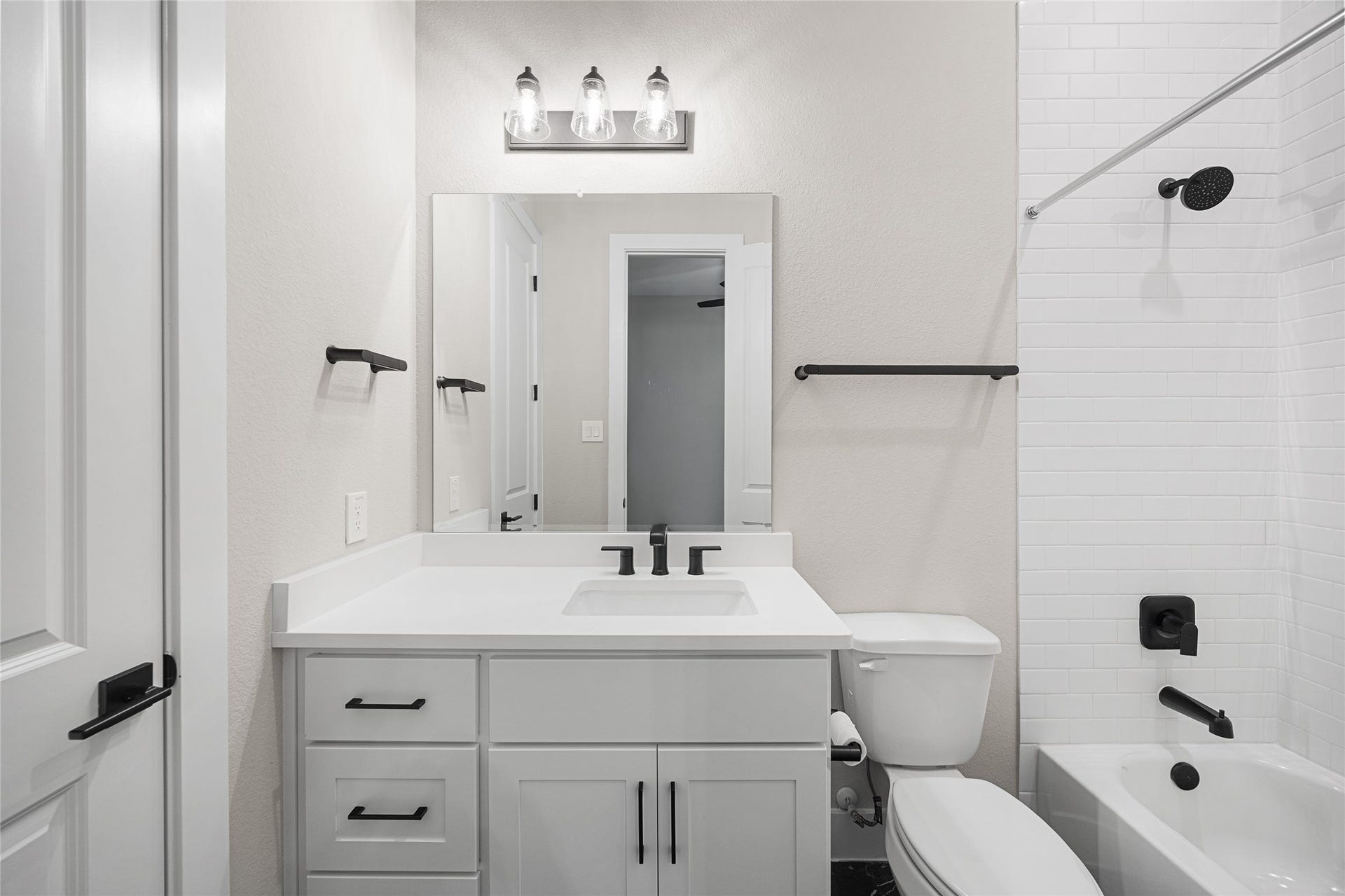 6707 Nimitz Court, Katy, TX 77493 Well-appointed bathroom with a modern vanity, matte black fixtures, and a tub/shower combination with tiled surround for a polished finish.