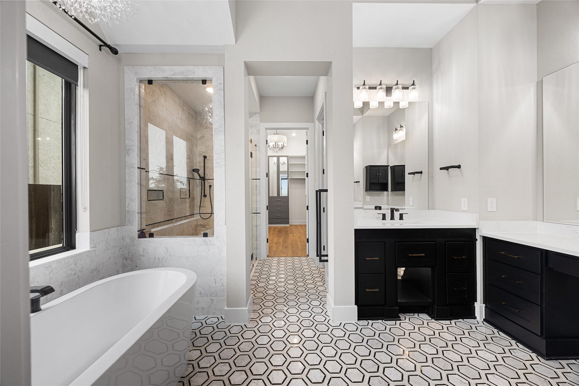 6707 Nimitz Court, Katy, TX 77493 Spa-inspired bath featuring a freestanding soaking tub, oversized walk-in shower with glass enclosure, and elegant tilework throughout.