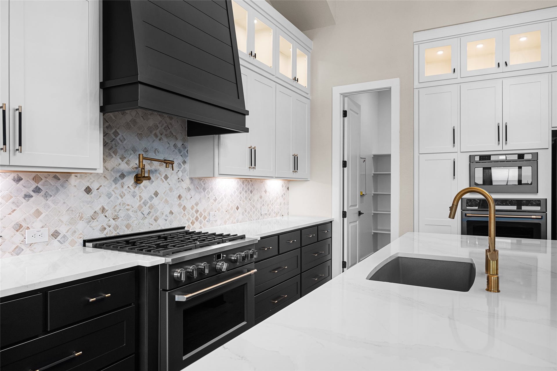 6707 Nimitz Court, Katy, TX 77493 Thoughtfully designed workspace with quartz counters, under-cabinet lighting, and seamless flow between prep, cooking, and serving areas.