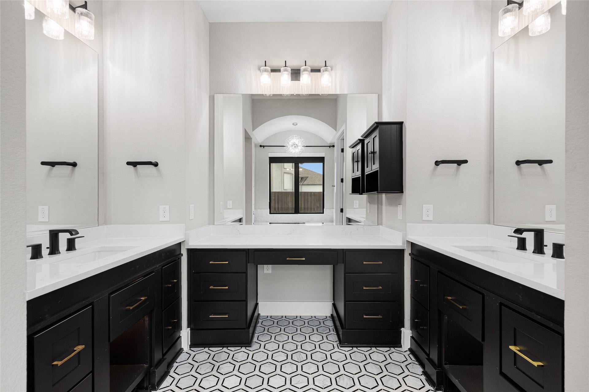 6707 Nimitz Court, Katy, TX 77493 Luxurious double vanity with quartz countertops, ample storage, and modern lighting, providing a functional and stylish space for daily routines.