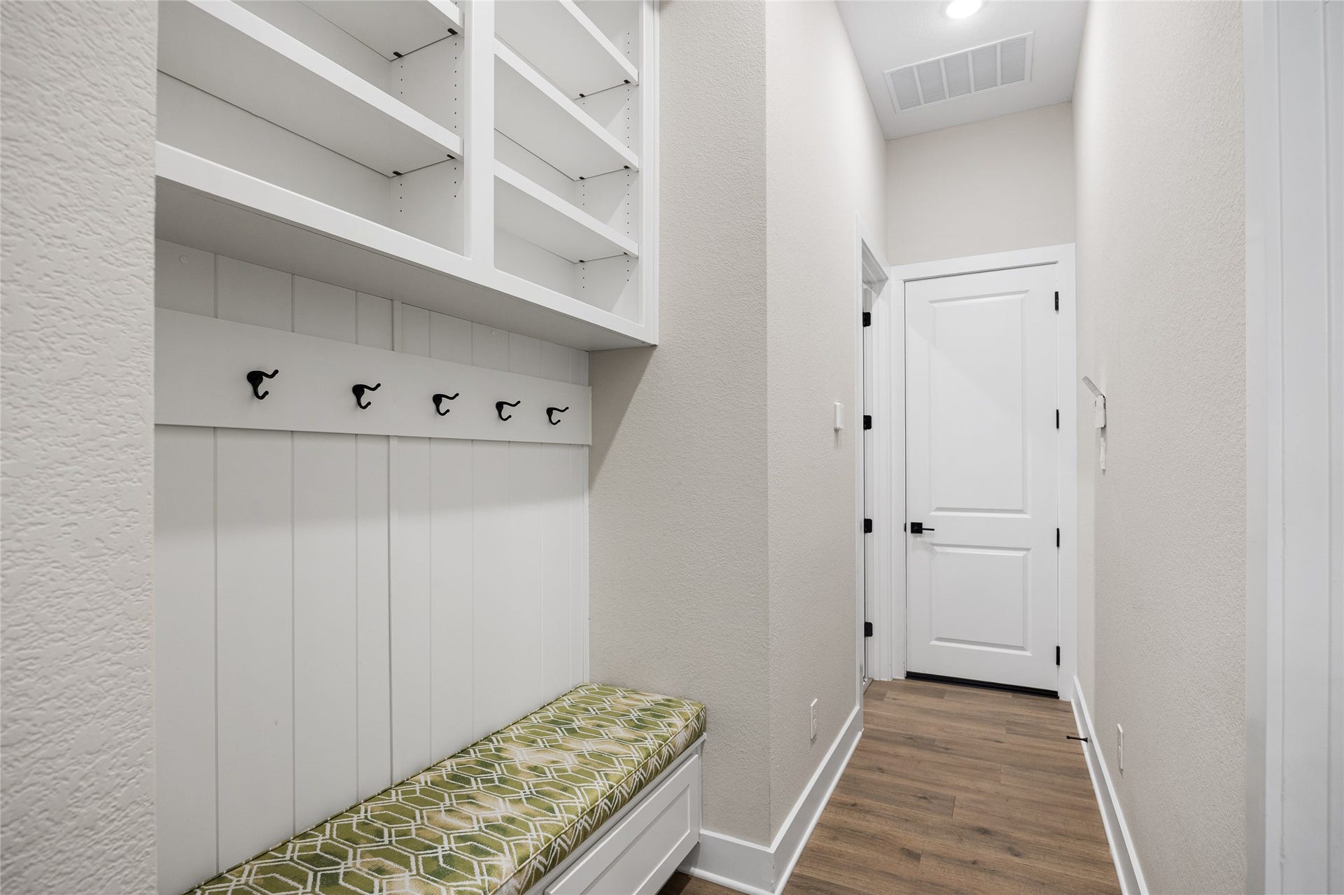 6707 Nimitz Court, Katy, TX 77493 Functional mudroom with built-in bench seating, overhead cubbies, and hooks, creating an organized drop zone for daily essentials.