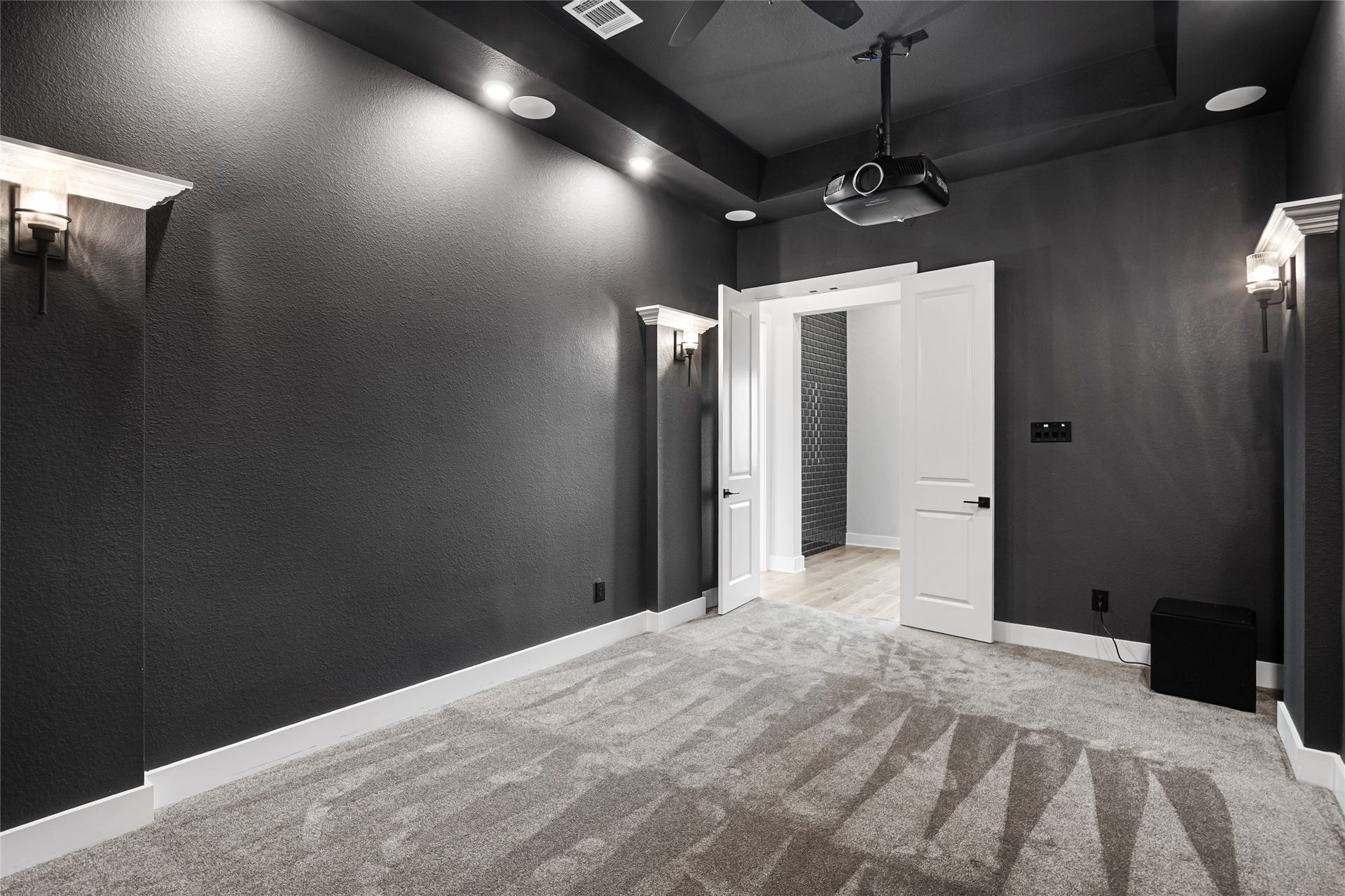 6707 Nimitz Court, Katy, TX 77493 Cozy, enclosed media space with plush carpeting, recessed lighting, and pre-wired projection system for an immersive entertainment experience.