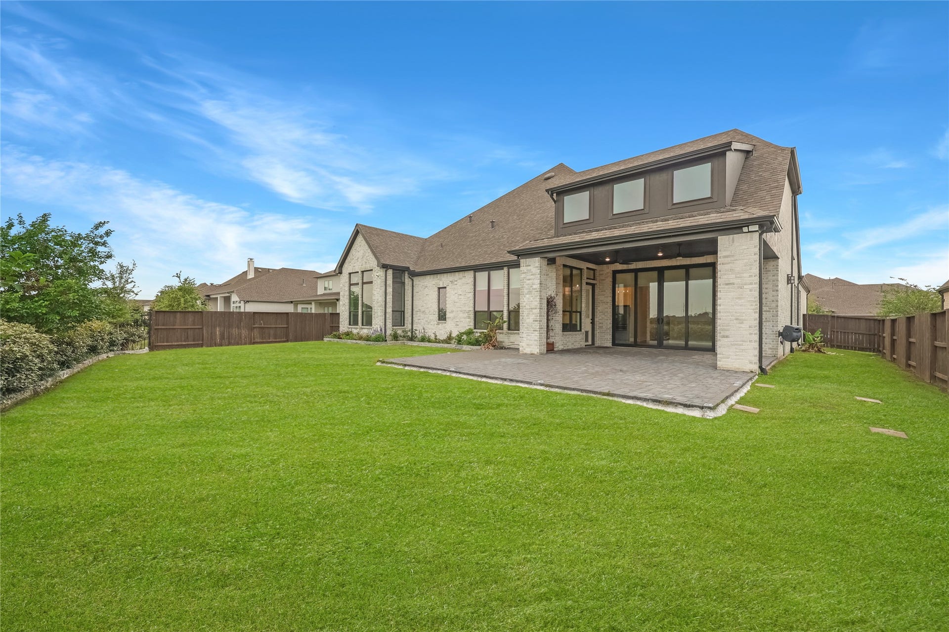 6707 Nimitz Court, Katy, TX 77493 Spacious, fully fenced backyard with lush green lawn and open views, offering plenty of room for recreation or future outdoor enhancements.