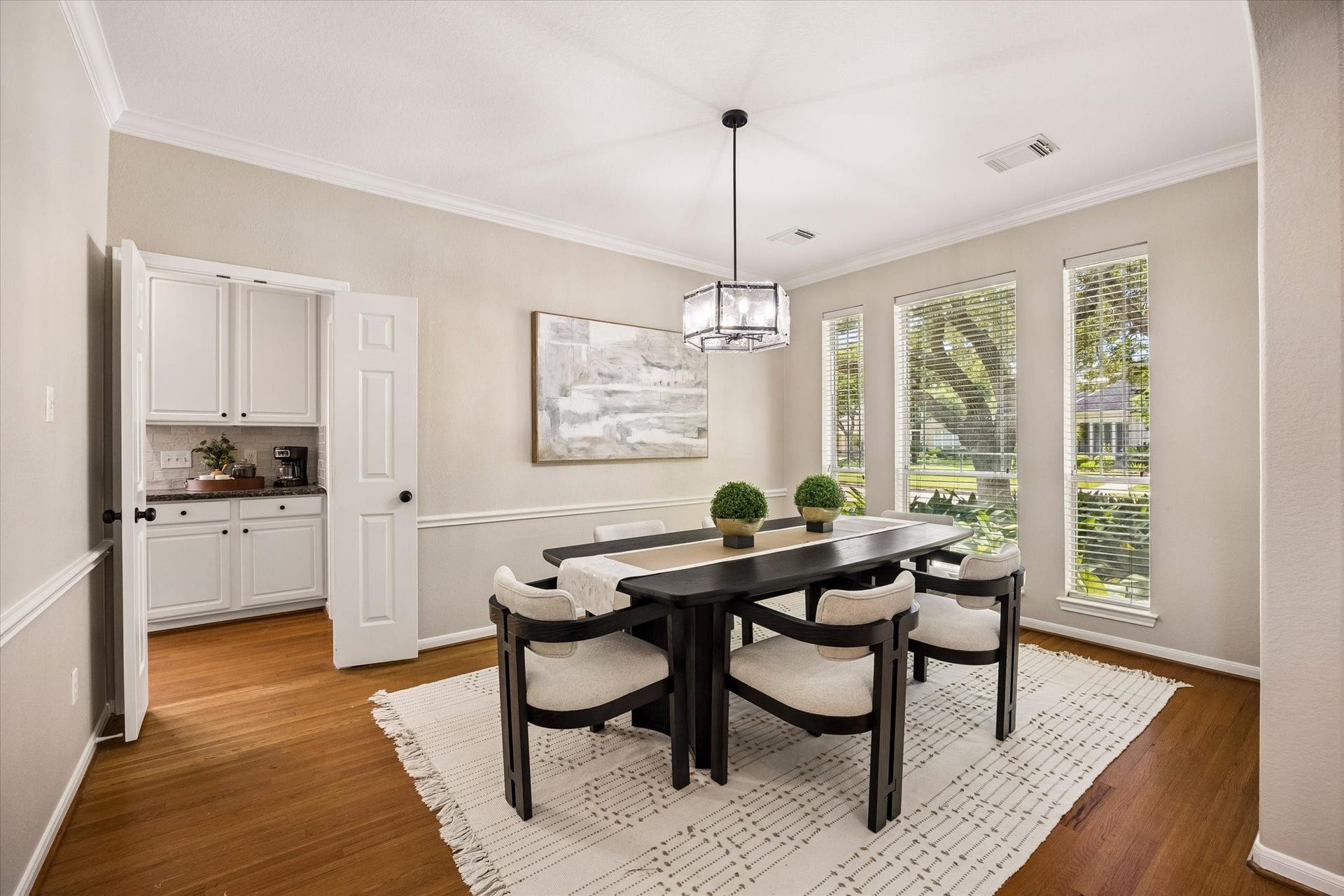 7535 Guinevere Drive, Sugar Land, TX 77479 Crown molding and oversized windows provide a refined backdrop for gatherings and special occasions. Chair rail, updated lighting, butler's pantry, and passage to the kitchen
