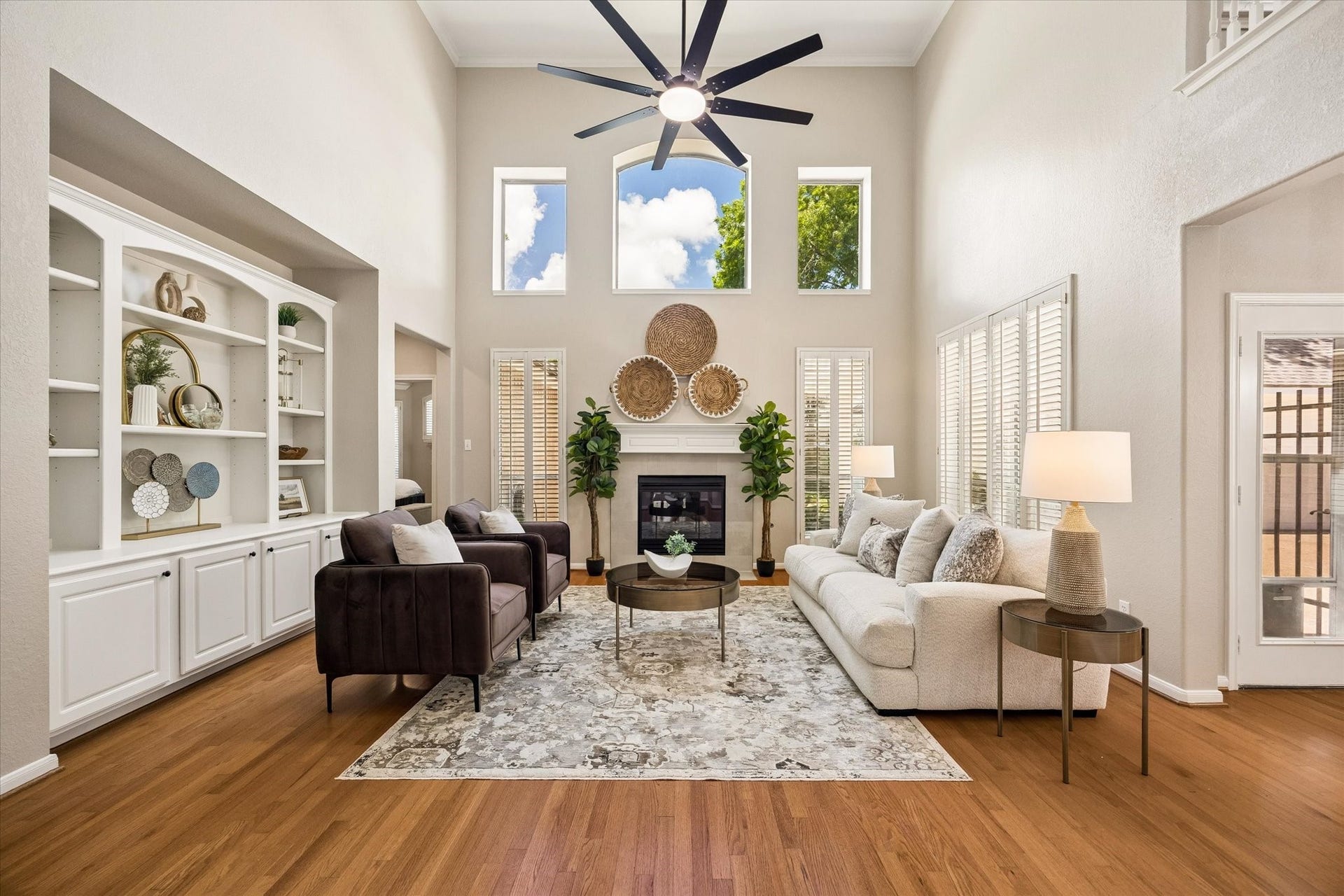7535 Guinevere Drive, Sugar Land, TX 77479 Towering ceilings, a gas fireplace, and custom built-ins give this living area scale & character. Updated ceiling fan, plantation shutters and natural light finish off this beautiful space