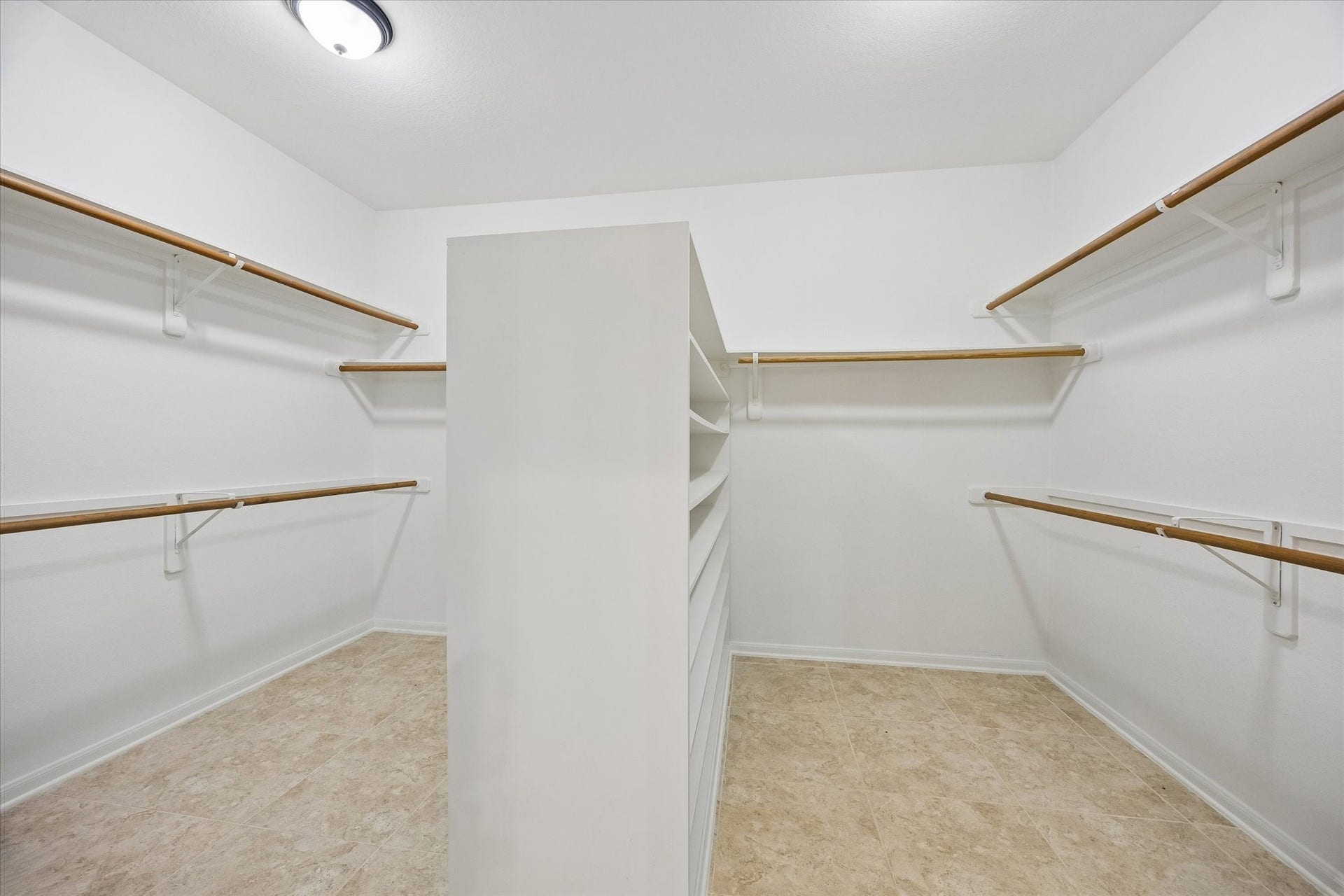 7535 Guinevere Drive, Sugar Land, TX 77479 The oversized walk-in closet features extensive hanging space and built-in shelving for effortless organization