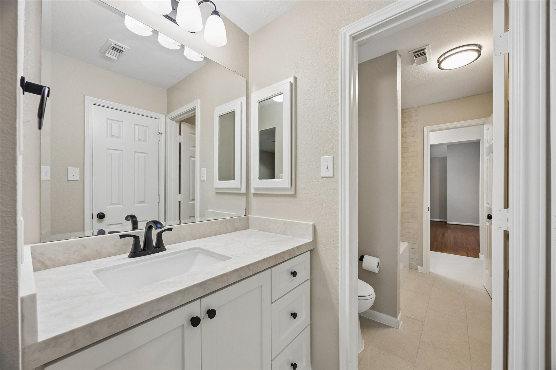 7535 Guinevere Drive, Sugar Land, TX 77479 The refreshed vanity features modern fixtures and ample counter space for everyday convenience