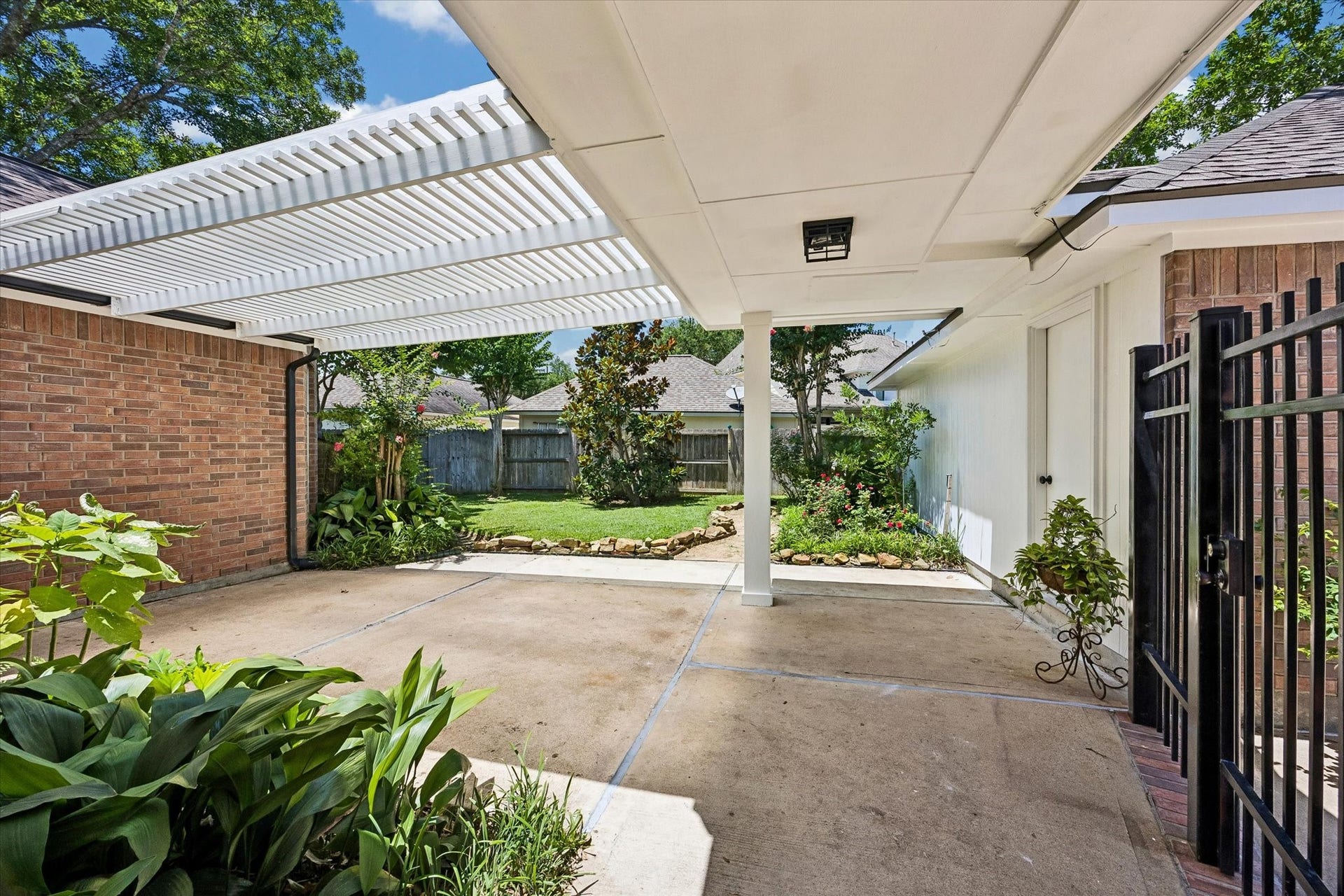 7535 Guinevere Drive, Sugar Land, TX 77479 The breezeway connects the home and garage while creating a private outdoor courtyard atmosphere
