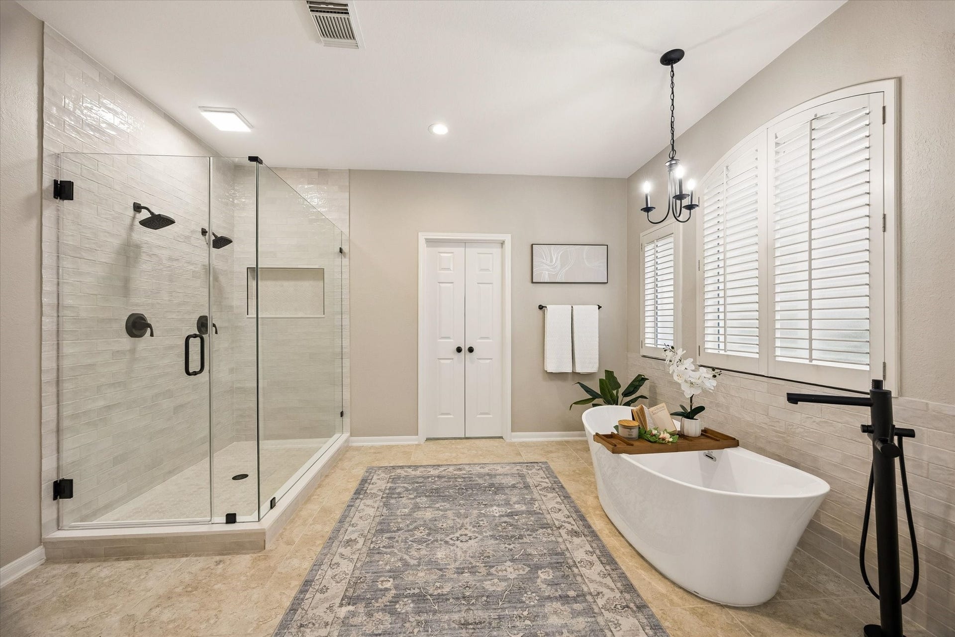 7535 Guinevere Drive, Sugar Land, TX 77479 Updated Primary Bath - A freestanding soaking tub and oversized walk-in shower with dual shower heads bring a spa-inspired feel to the space