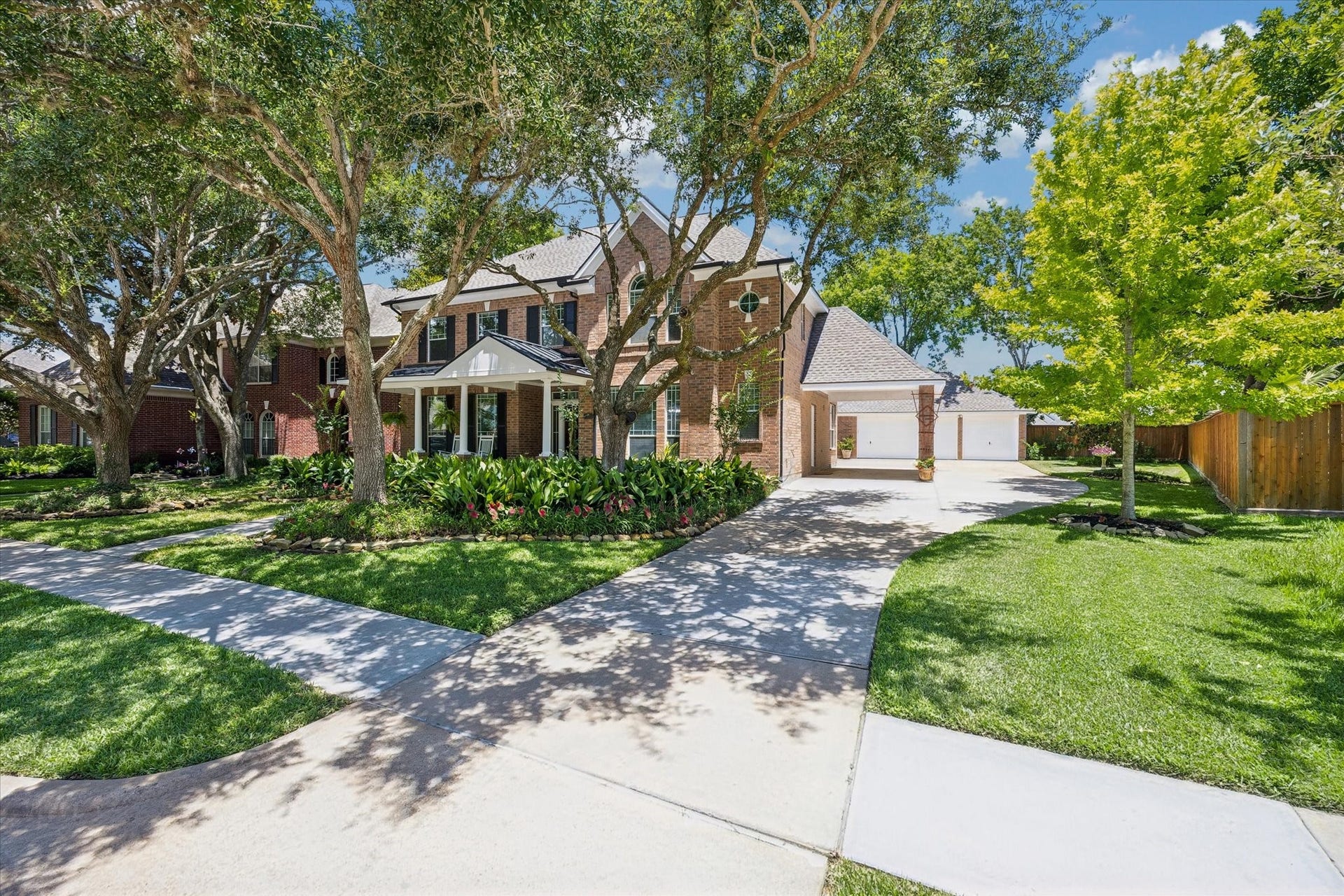 7535 Guinevere Drive, Sugar Land, TX 77479 A covered front porch elevation with elegant details provides a charming and welcoming entry