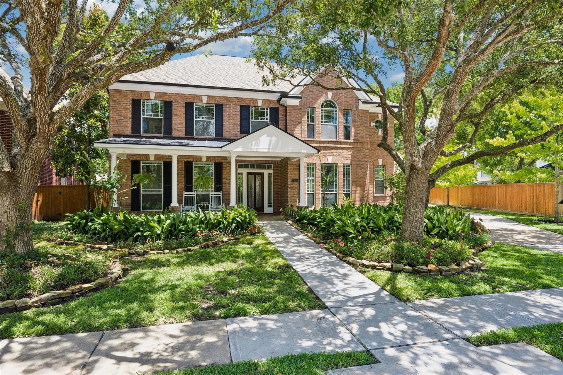 7535 Guinevere Drive, Sugar Land, TX 77479 A spacious driveway and 3 car garage, covered portico with entry to near the kitchen. 2026 roof, freshly painted exterior