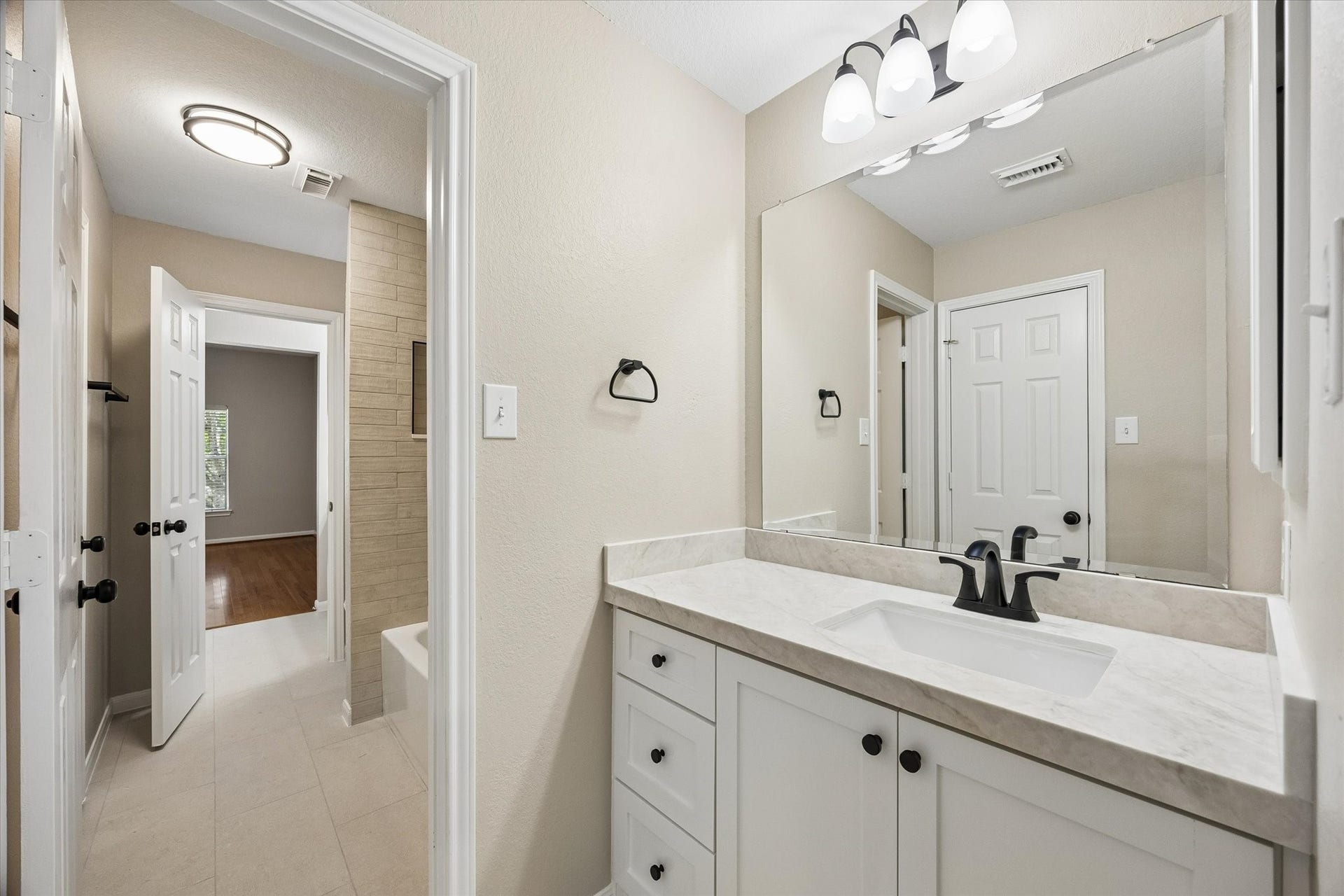 7535 Guinevere Drive, Sugar Land, TX 77479 Udated cabinet, counter, faucet, sink in the Jack and Jill vanity