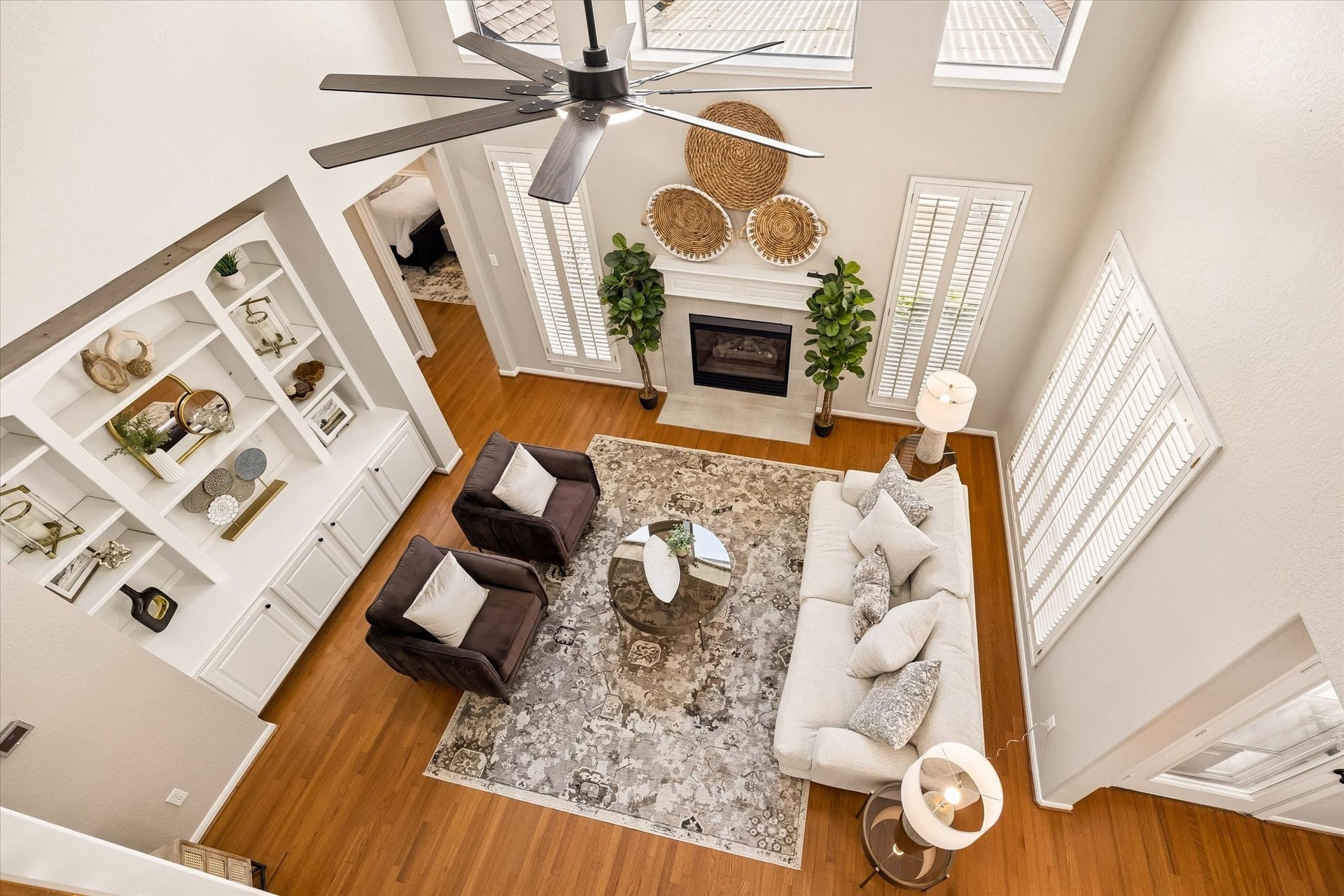 7535 Guinevere Drive, Sugar Land, TX 77479 Towering ceilings, a gas fireplace, and custom built-ins give this living area scale & character. Updated ceiling fan, plantation shutters and natural light finish off this beautiful family room