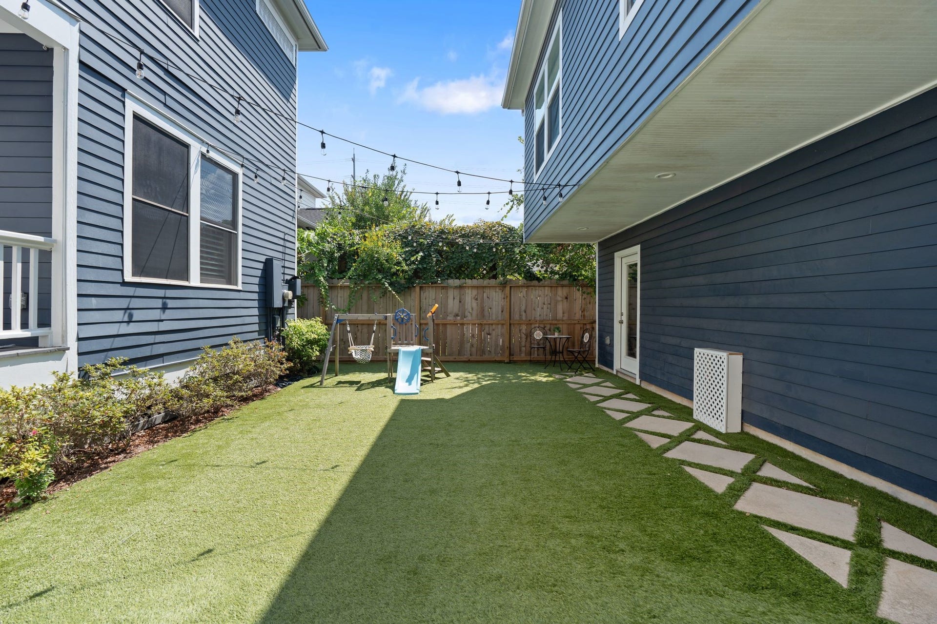 919 Ashland Street, #A, Houston, TX 77008 Another view of the backyard showcasing the 2-car garage on your right w/ alley access + large storage closet. Separate door on your right provides private access to the fully equipped GARAGE APARTMENT located abovean incredible bonus to the property!
