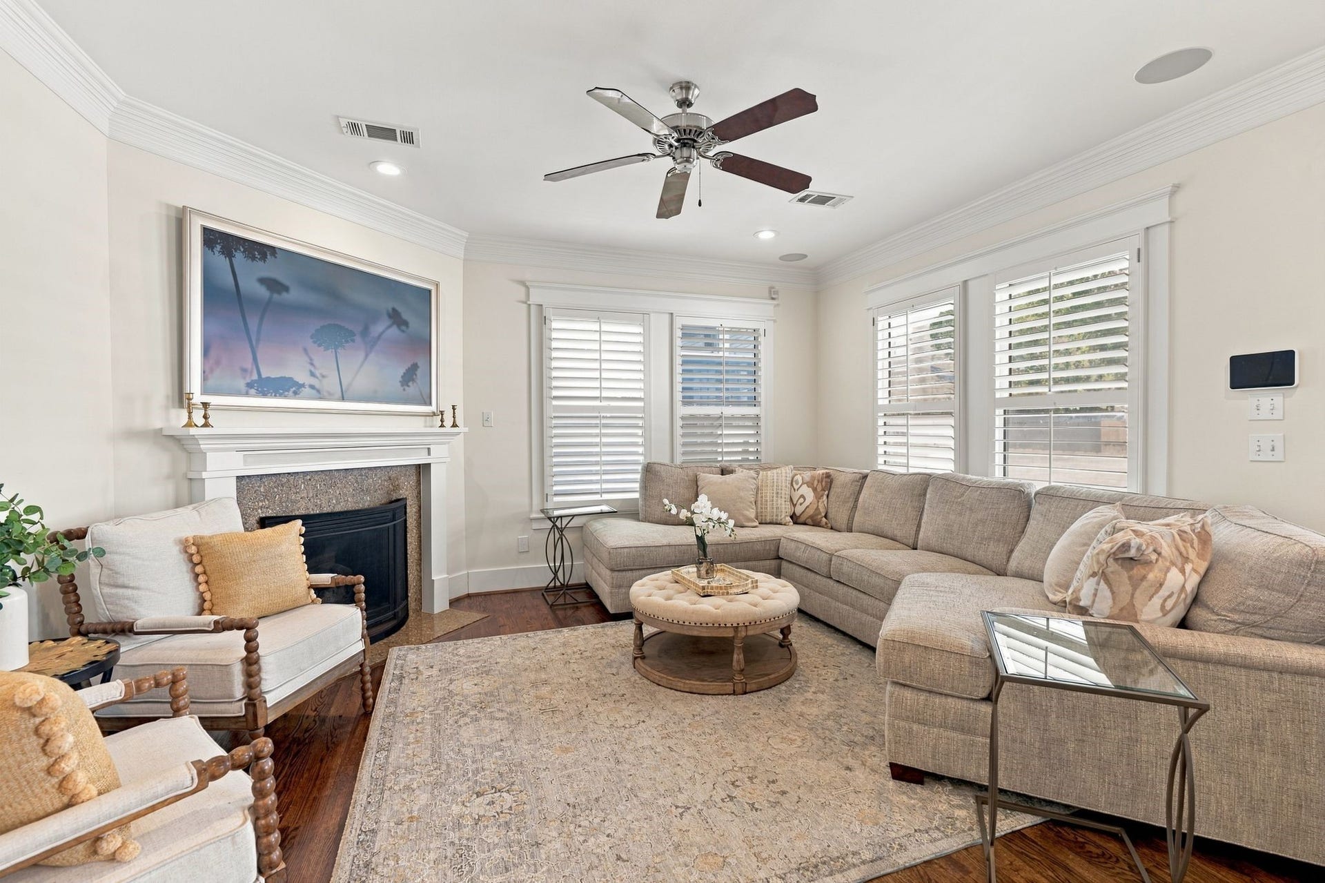 919 Ashland Street, #A, Houston, TX 77008 Spacious light-filled family room w/ windows overlooking the backyard, plantation shutters, ceiling fan + in-ceiling speakers. Gas-log fireplace w/ custom mantel creates a warm & inviting focal point. Fireplace mantel updated 23.