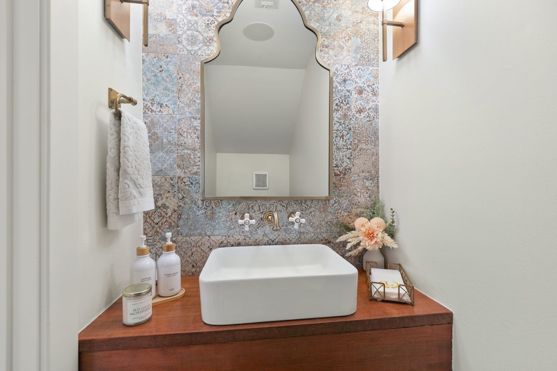 919 Ashland Street, #A, Houston, TX 77008 Beautiful first-floor powder bath remodeled 20 w/ floating wood vanity, vessel sink + wall-mounted faucet. Decorative mirror & dual sconces complete this stylish guest bath.