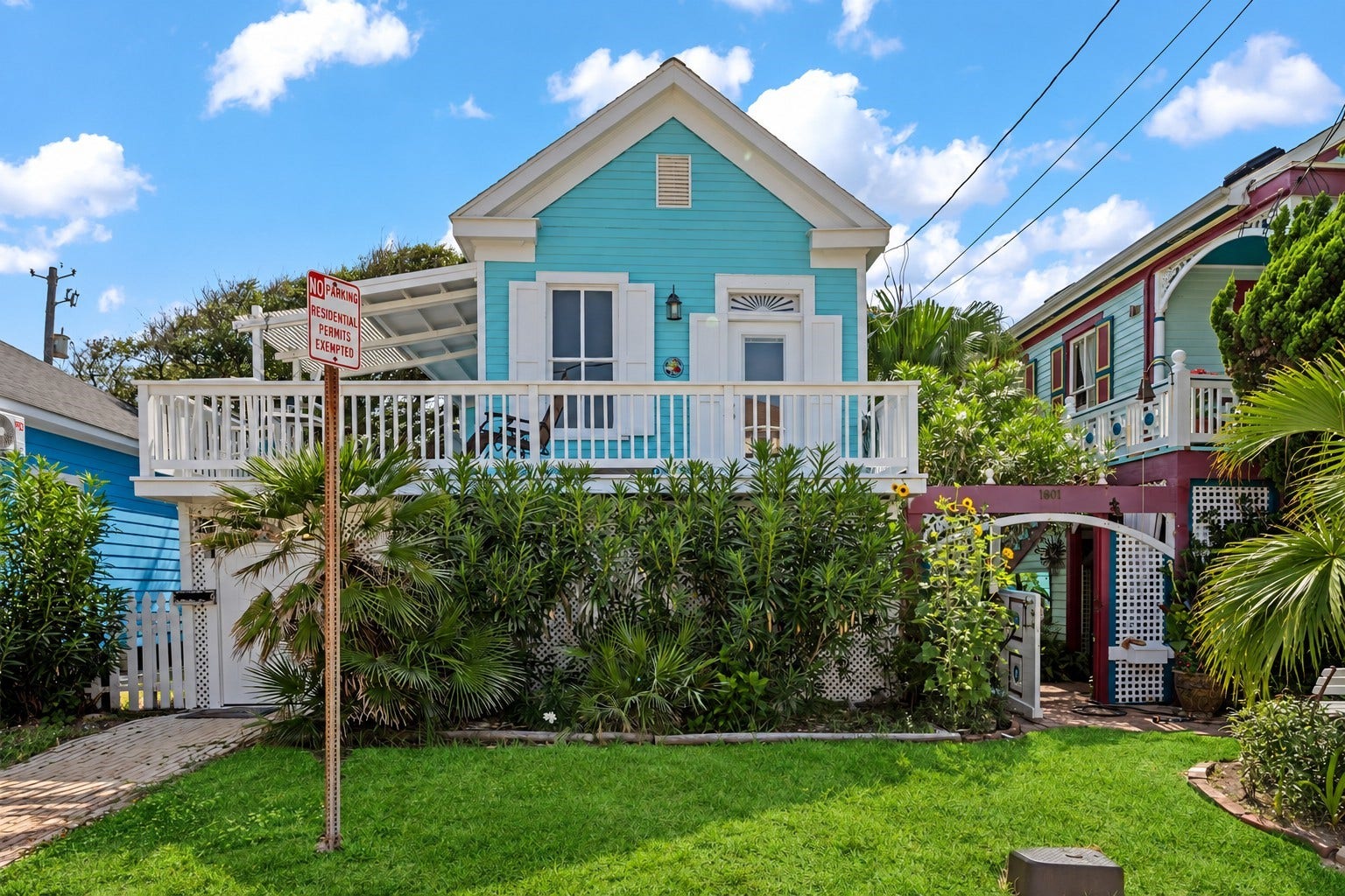 1805 19th Street, Galveston, TX 77550 Charming coastal cottage with an inviting elevated front porch, tropical landscaping, and bright island-inspired exterior. Located approximately a block and a half from the beach, offering easy access to the Seawall, Gulf, dining, and nearby Galveston attractions.