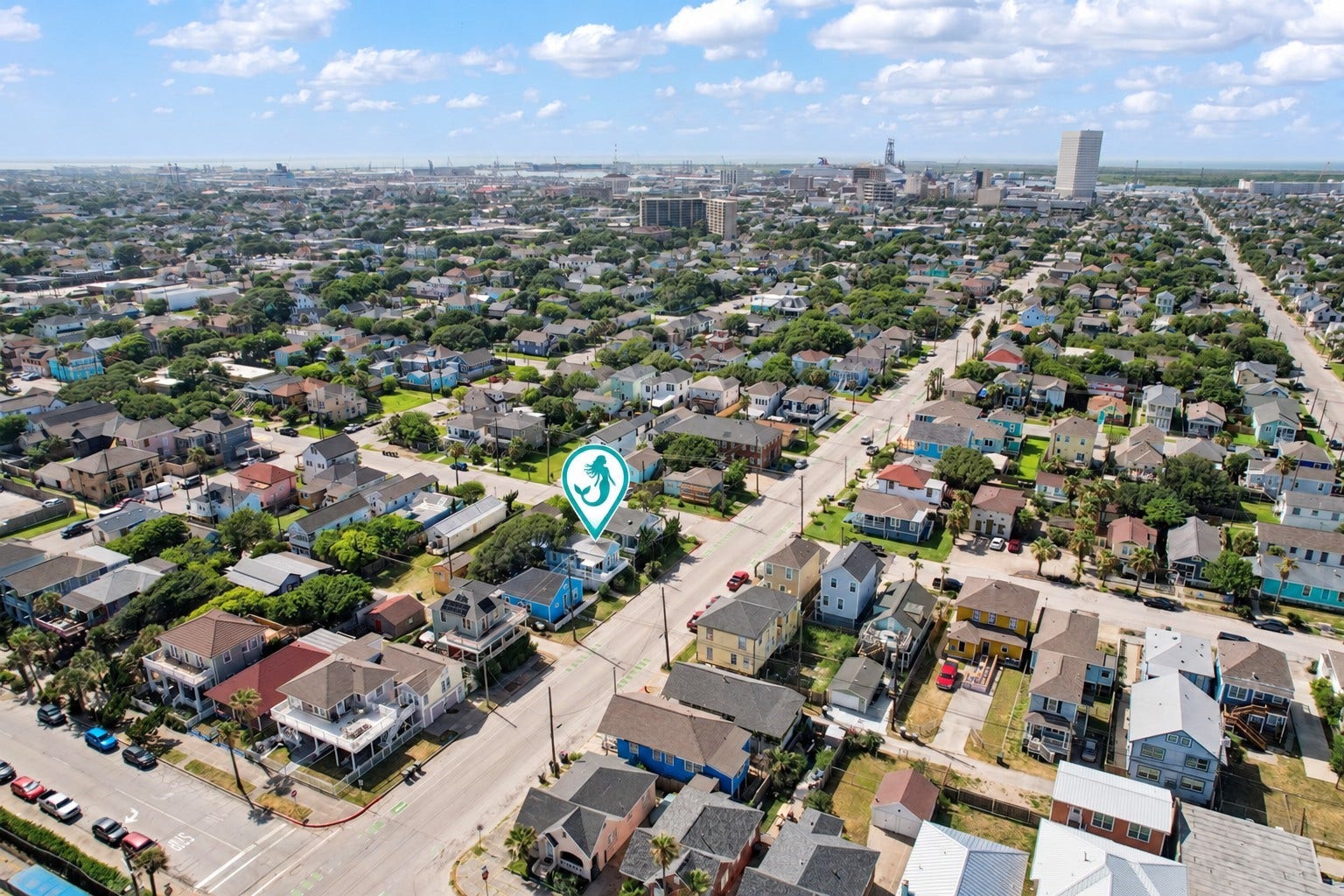 1805 19th Street, Galveston, TX 77550 Aerial view highlighting the property's location among Galveston's charming coastal homes, with downtown Galveston and the Port of Galveston visible in the distance.