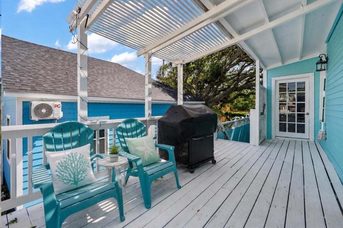 1805 19th Street, Galveston, TX 77550 Second-Floor Outdoor Deck: Embrace the Galveston coastal lifestyle on this inviting second-floor deck featuring a charming pergola, outdoor seating, and grilling area. With direct access from the living room, this outdoor retreat is perfect for entertaining, relaxing in the Gulf breeze, or unwinding after a day at the beach!