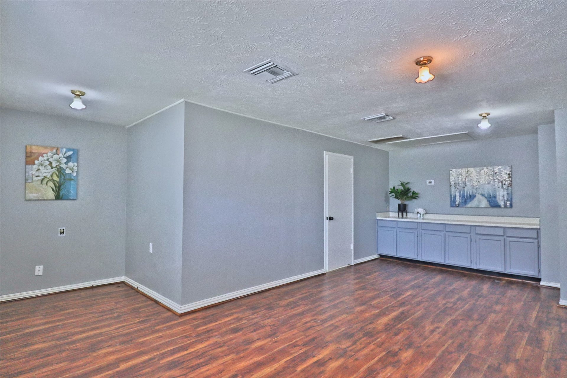 spacious game room with built in cabinets