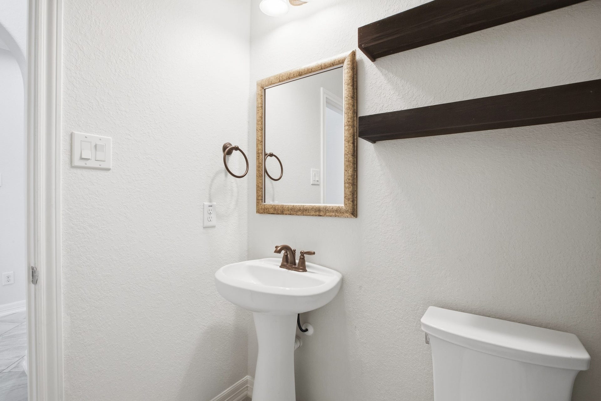 9975 Spring Rock Lane, Brookshire, TX 77423 Half bathroom with floating shelves, located down stairs for guests