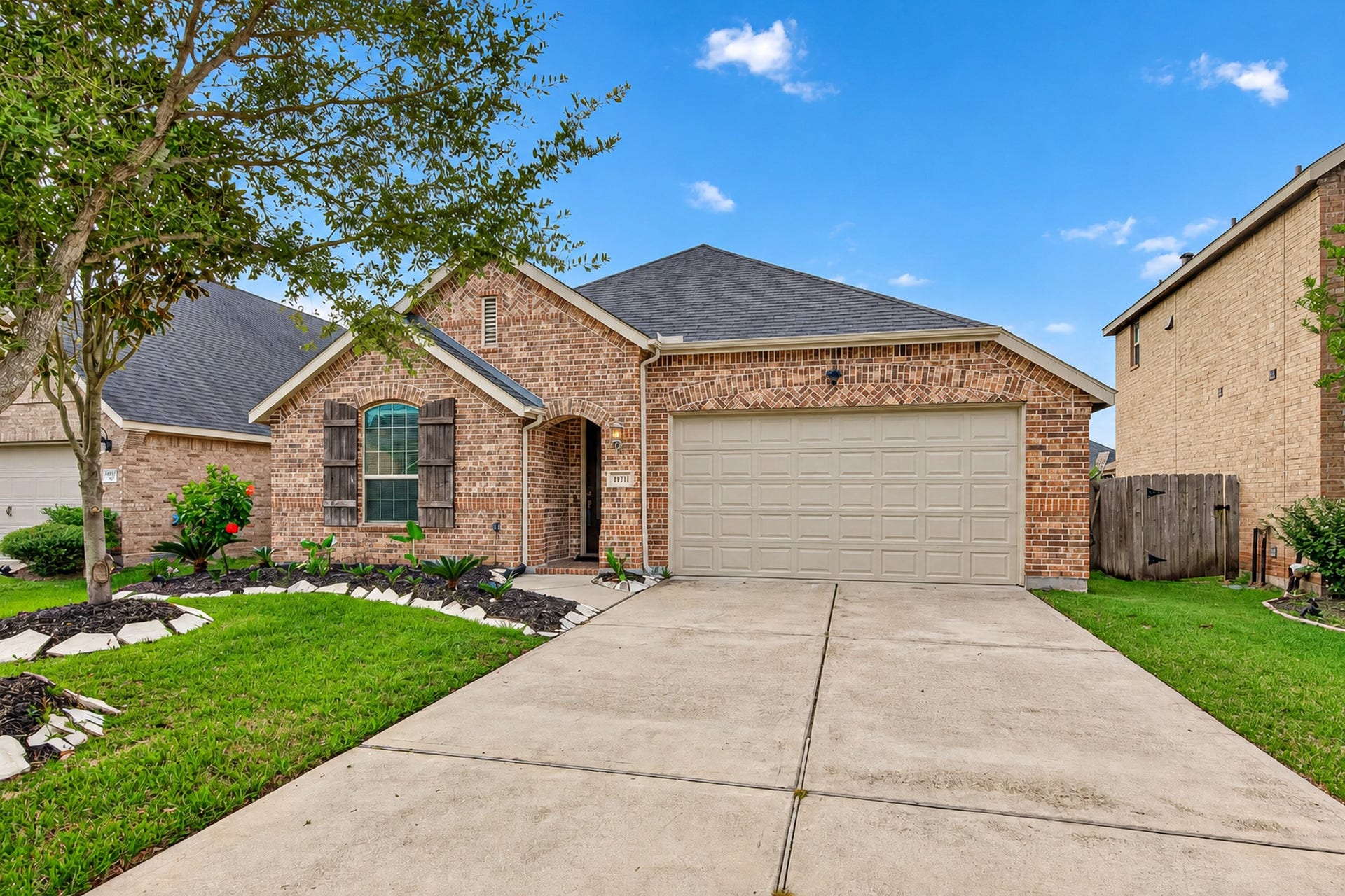 19711 Lakeside Pointe, Richmond, TX 77407 timeless brick charm, a covered entry, and attractive landscaping that creates an inviting first impression