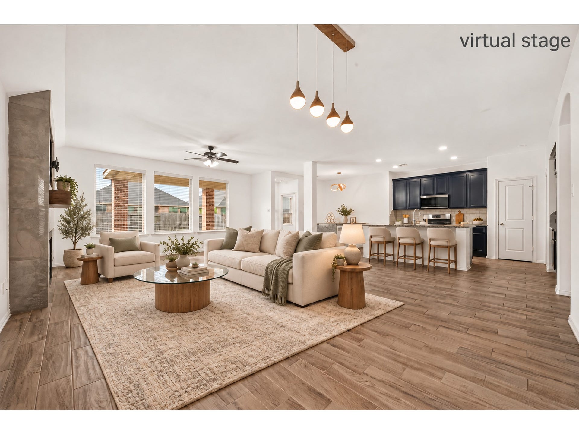 19711 Lakeside Pointe, Richmond, TX 77407 An airy, open layout connects the living area and kitchen, with generous windows, wood-look flooring, and a striking dark-cabinet backdrop for everyday living and entertaining