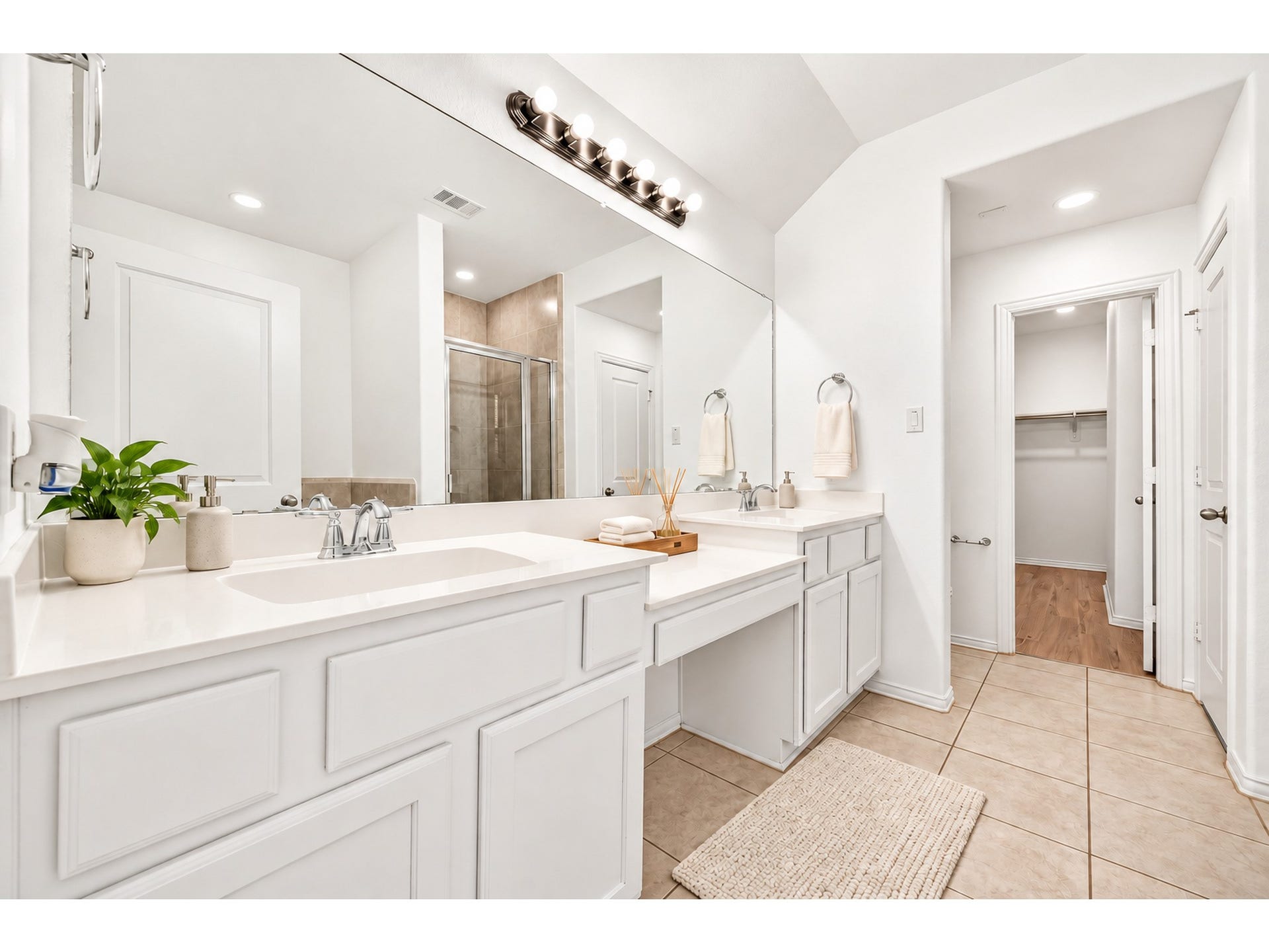 19711 Lakeside Pointe, Richmond, TX 77407 Bright and inviting, this bathroom features an expansive vanity, generous mirror space, and a glass-enclosed shower for a fresh, relaxing feel. Decorative accessories are virtually added