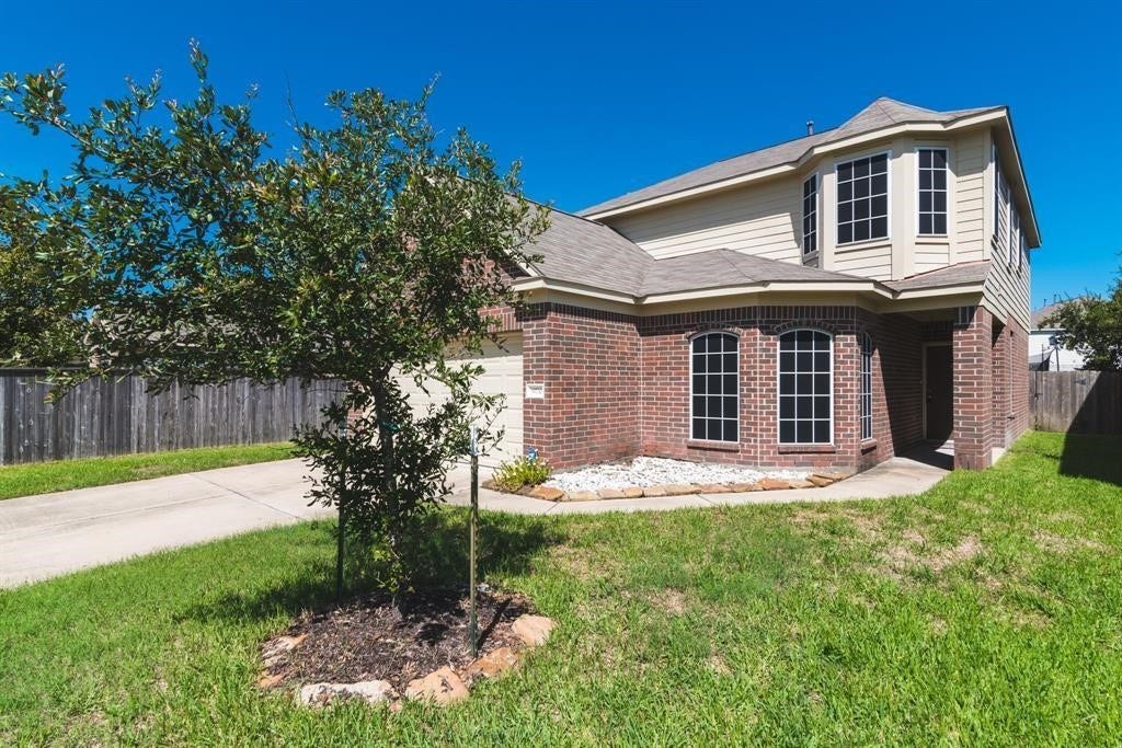 A large front yard and mature landscape