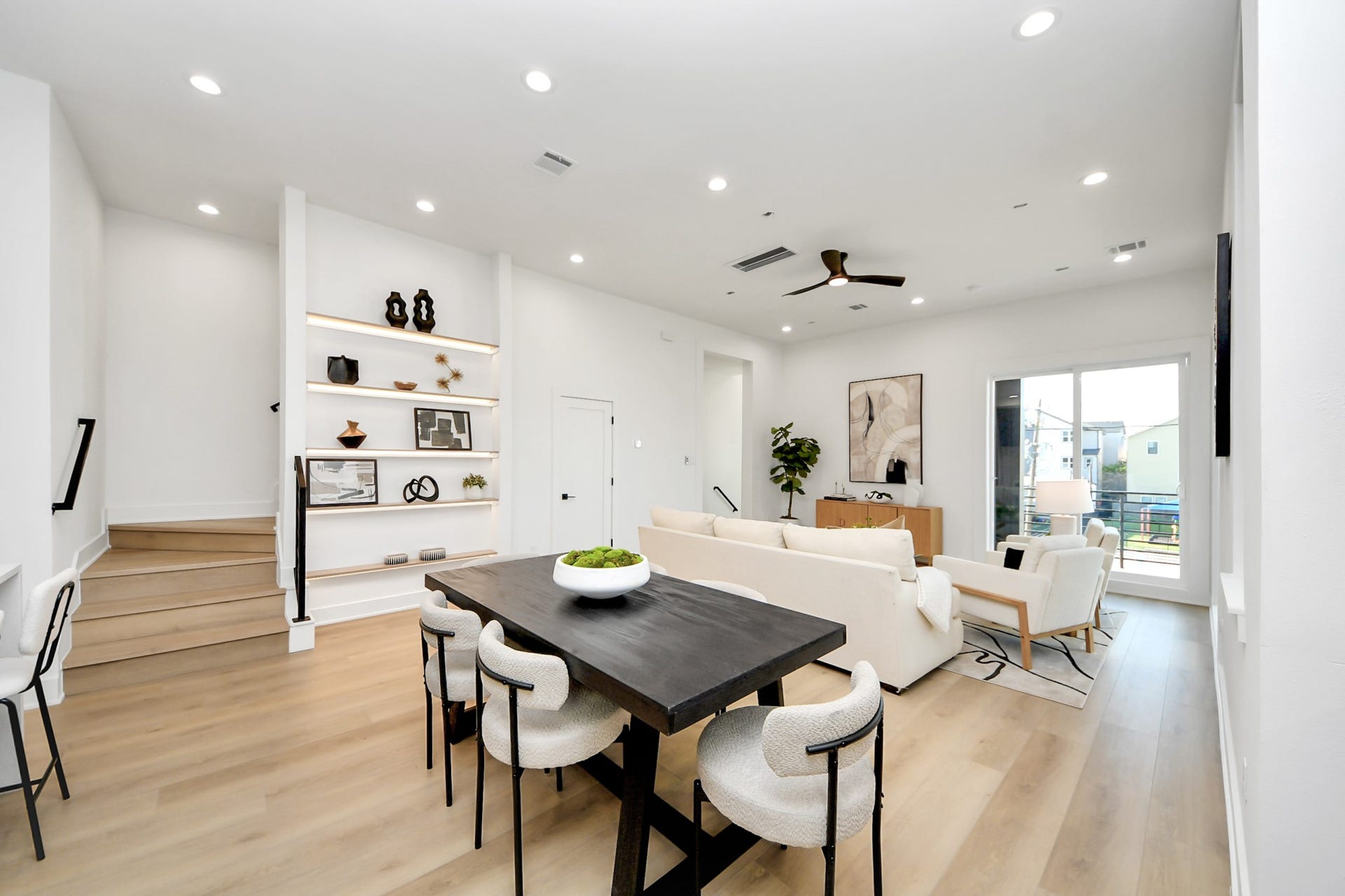 1603 W 25th Street, Houston, TX 77008 Spacious second-floor dining and living area with custom shelving and direct access to the balcony.