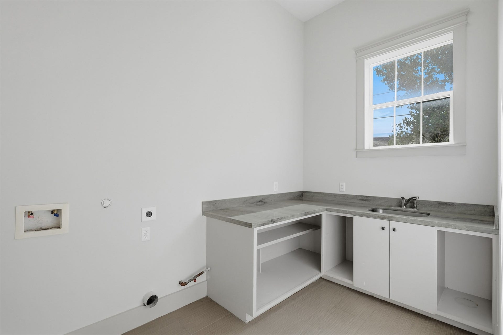 16017 Kube Court, Jersey Village, TX 77040 Laundry room with sink and storage