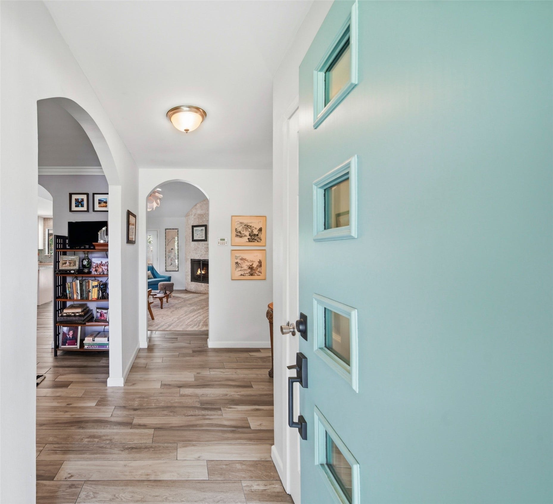 From the moment you enter, you'll appreciate the bright, airy foyer, timeless archways, and beautiful flooring that flows throughout the main living areas. This inviting entry offers a glimpse of the home's spacious layout and comfortable design.