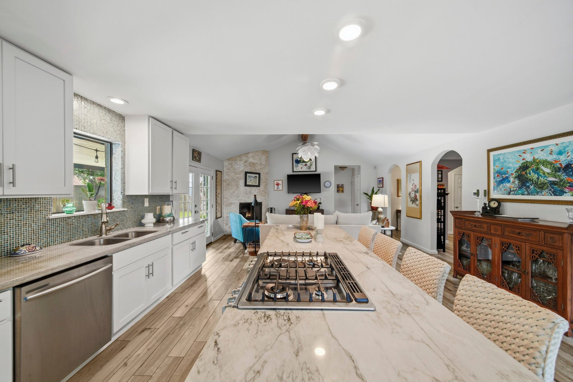 The open kitchen flows seamlessly into the living area, enhanced by natural light and beautiful flooring throughout. Perfect for everyday living and entertaining!