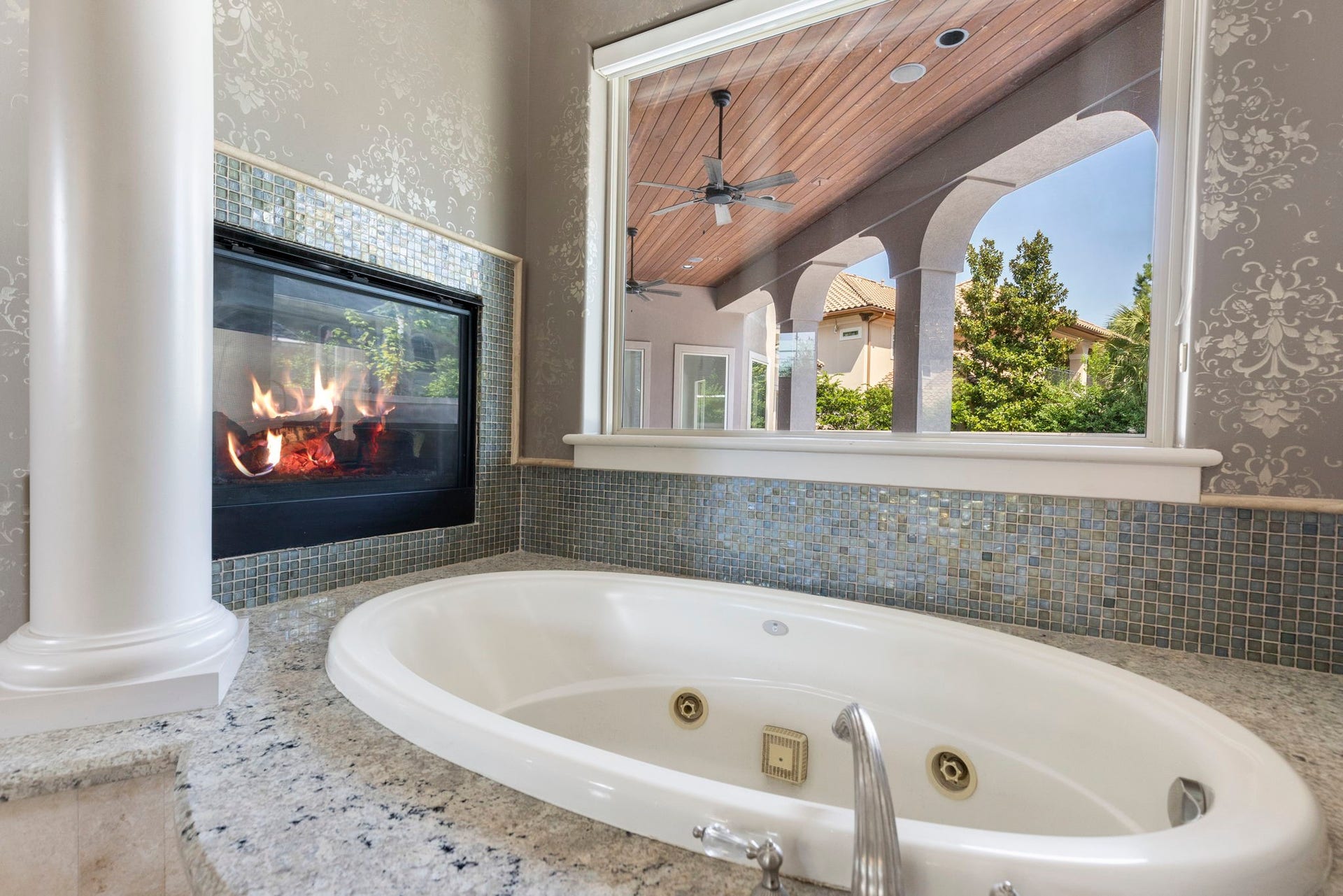 47 Hunnewell Way, The Woodlands, TX 77382 The tub invites you to relax fireside while taking in a tranquil tree top view.