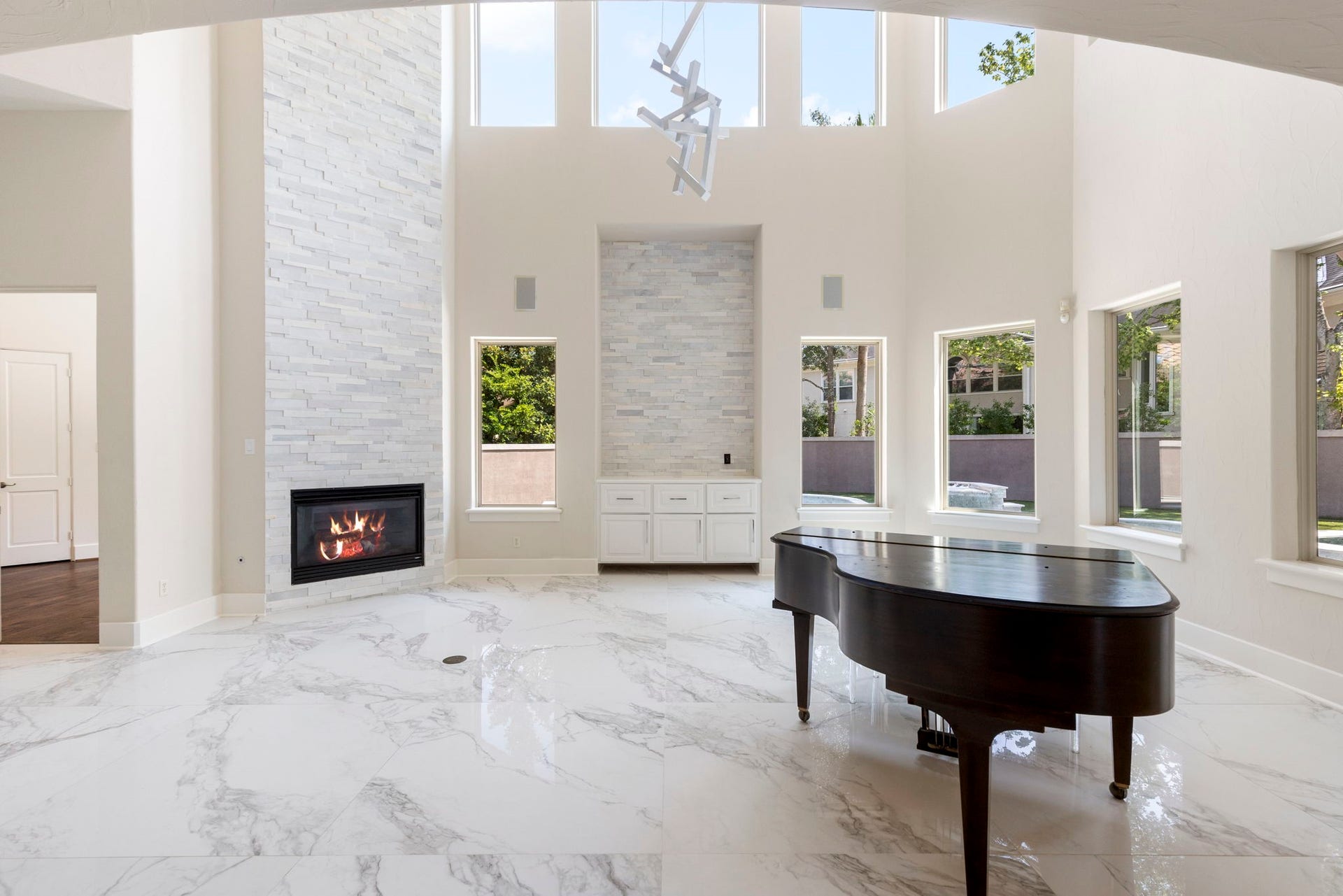 47 Hunnewell Way, The Woodlands, TX 77382 The fireplace has been updated with stacked stone from floor to ceiling, complemented by a remodeled media niche framed in the same stone detail.