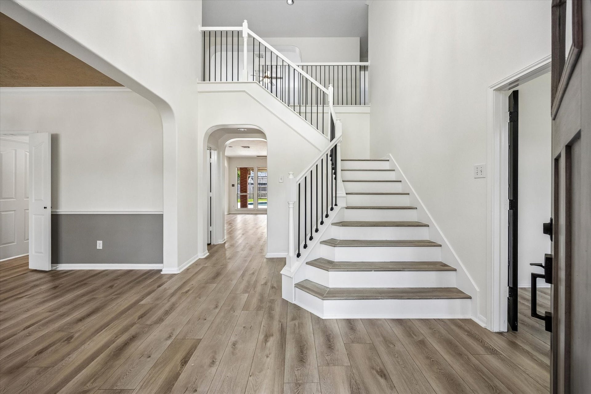 1331 SHADY BEND DRIVE, Sugar Land, TX 77479 The dramatic two-story foyer welcomes you with soaring ceilings, a sweeping staircase, and durable luxury vinyl plank flooring.