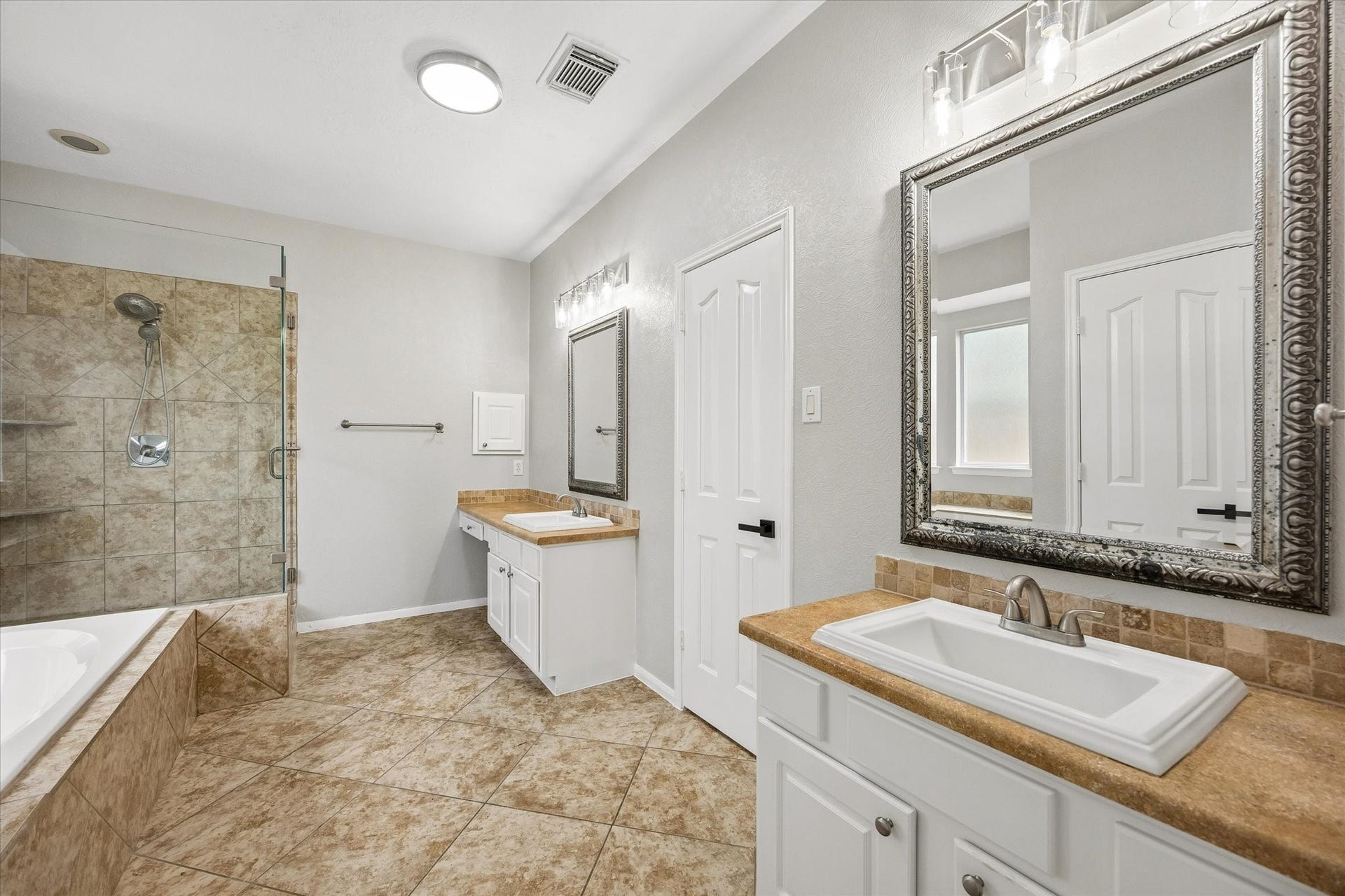 1331 SHADY BEND DRIVE, Sugar Land, TX 77479 The primary bathroom features dual vanities, a soaking tub, a walk-in shower, and ample storage.