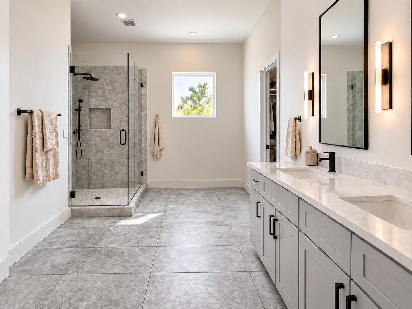 6031 Beall Street, Houston, TX 77091 Indulge in the comfort of this spacious primary bathroom featuring sophisticated contemporary finishes and a beautifully coordinated neutral palette. A large double-sink vanity offers generous countertop space, ample cabinetry, sleek black fixtures, and elegant framed mirrors. The oversized glass-enclosed shower showcases decorative tile, a rainfall showerhead, and a built-in storage niche. These photos have been virtually rendered for visual reference.
